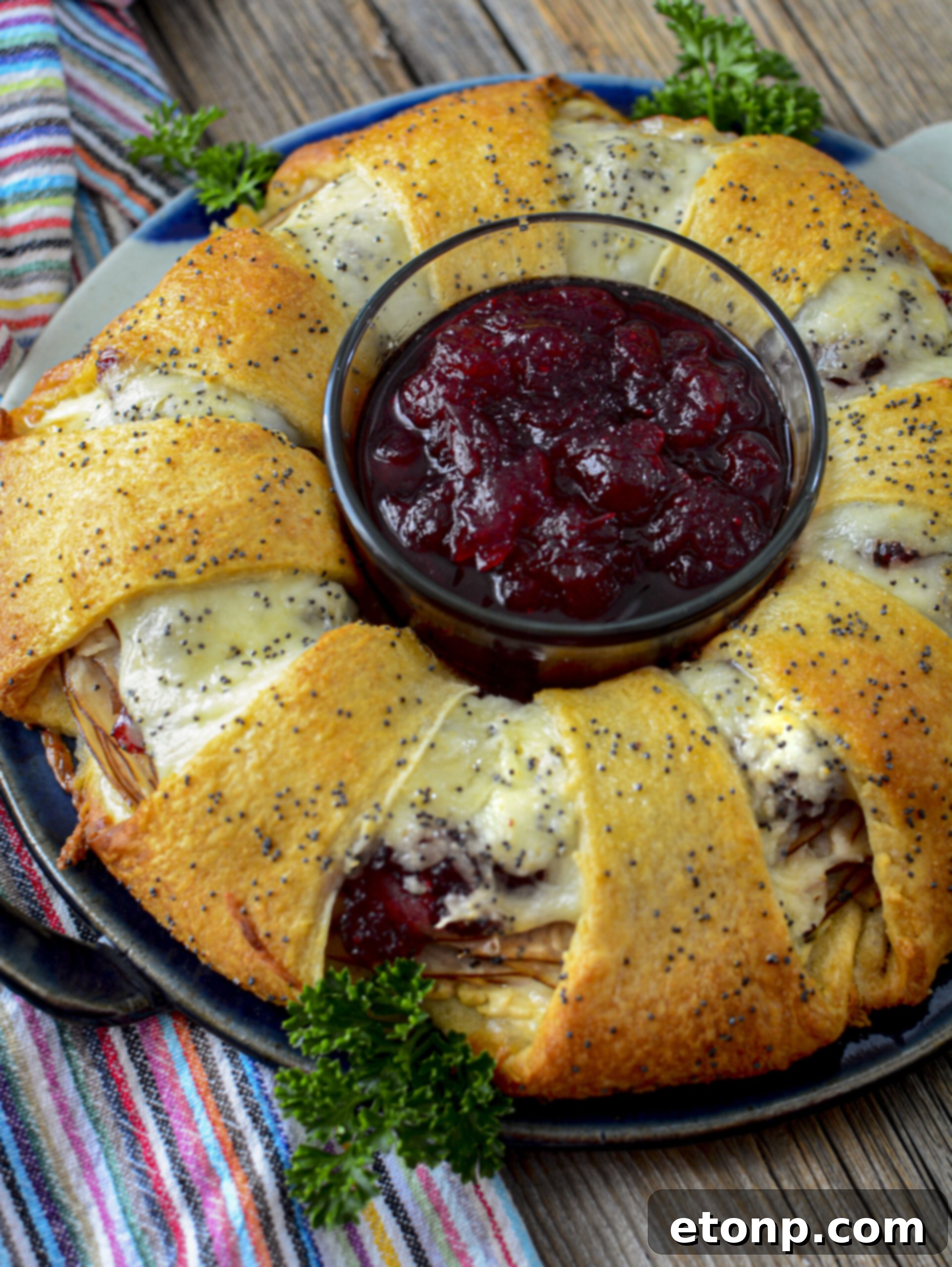 Turkey Crescent Roll Ring with a bowl of cranberry sauce in the center