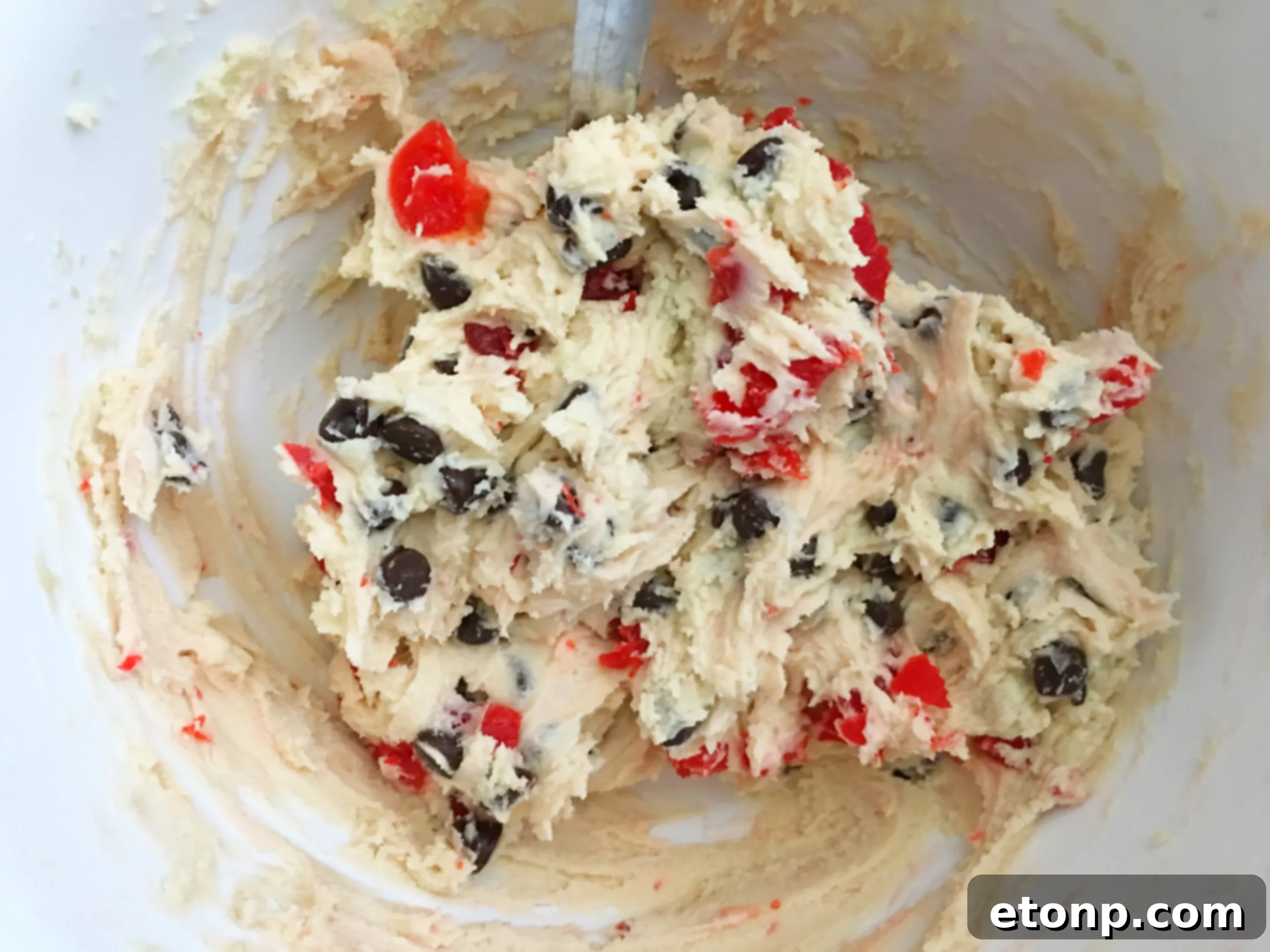 Buttery Maraschino Cherry Christmas Shortbread 5 Hands gently kneading the cookie dough to ensure all ingredients are well combined.