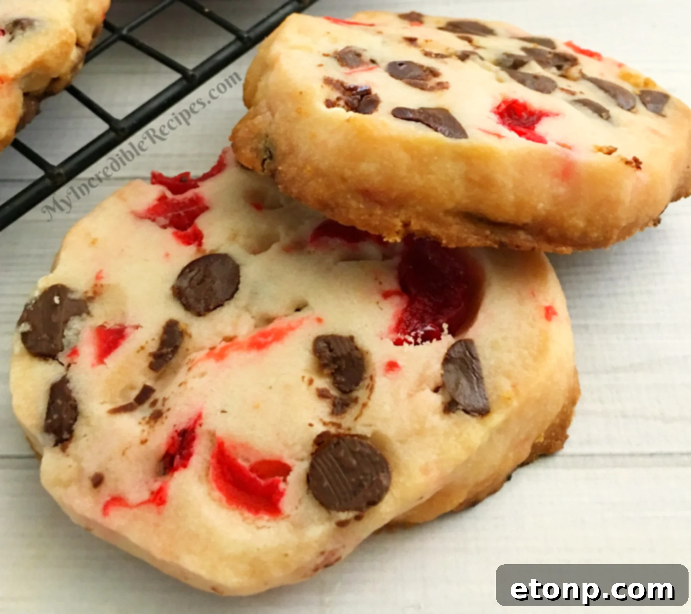 Buttery Maraschino Cherry Christmas Shortbread 9 An array of freshly baked Maraschino Cherry Shortbread Christmas Cookies on a festive plate.