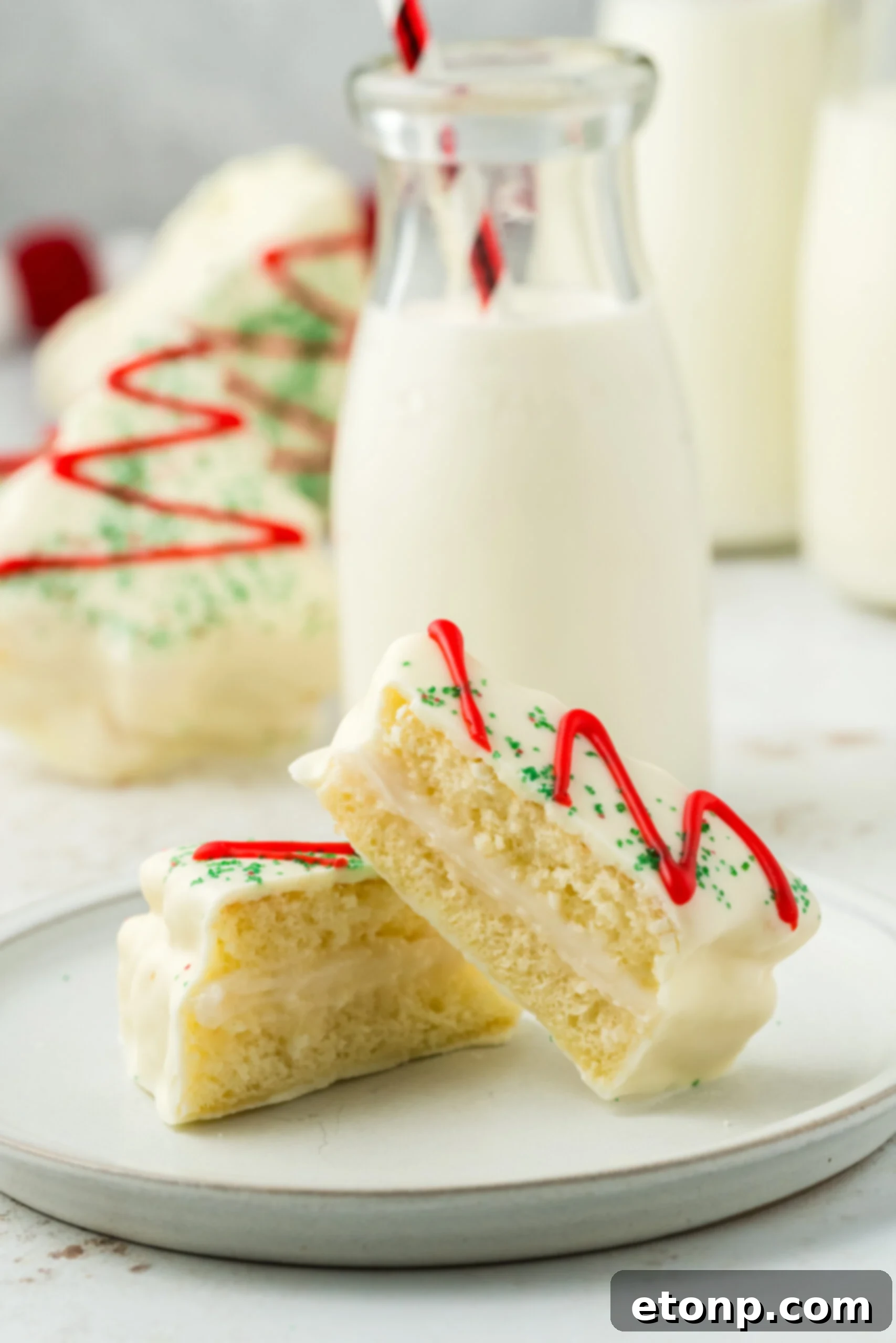 little debbies christmas tree cake cut in half on plate