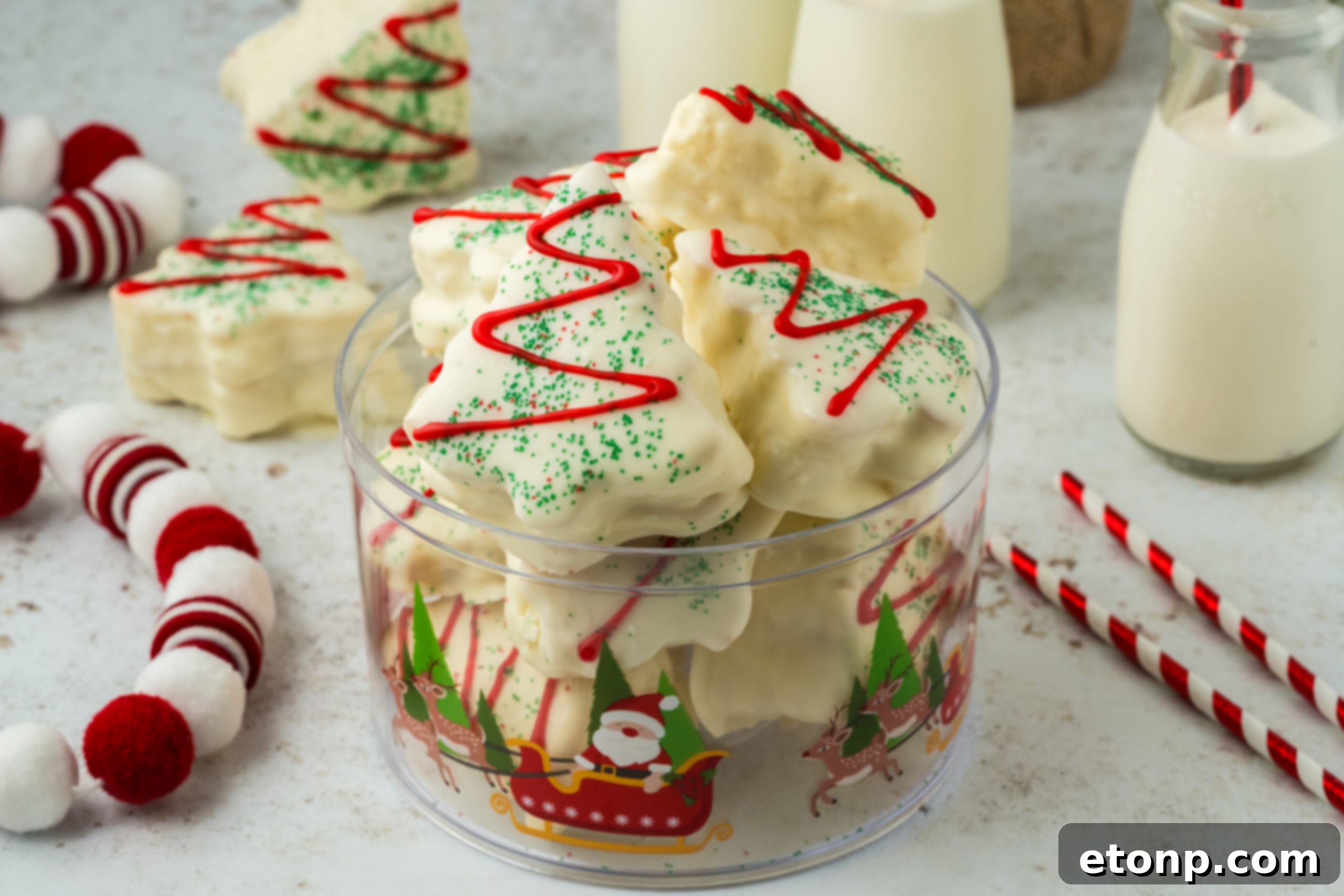 cakes in a glass bowl on table with Christmas decor around it
