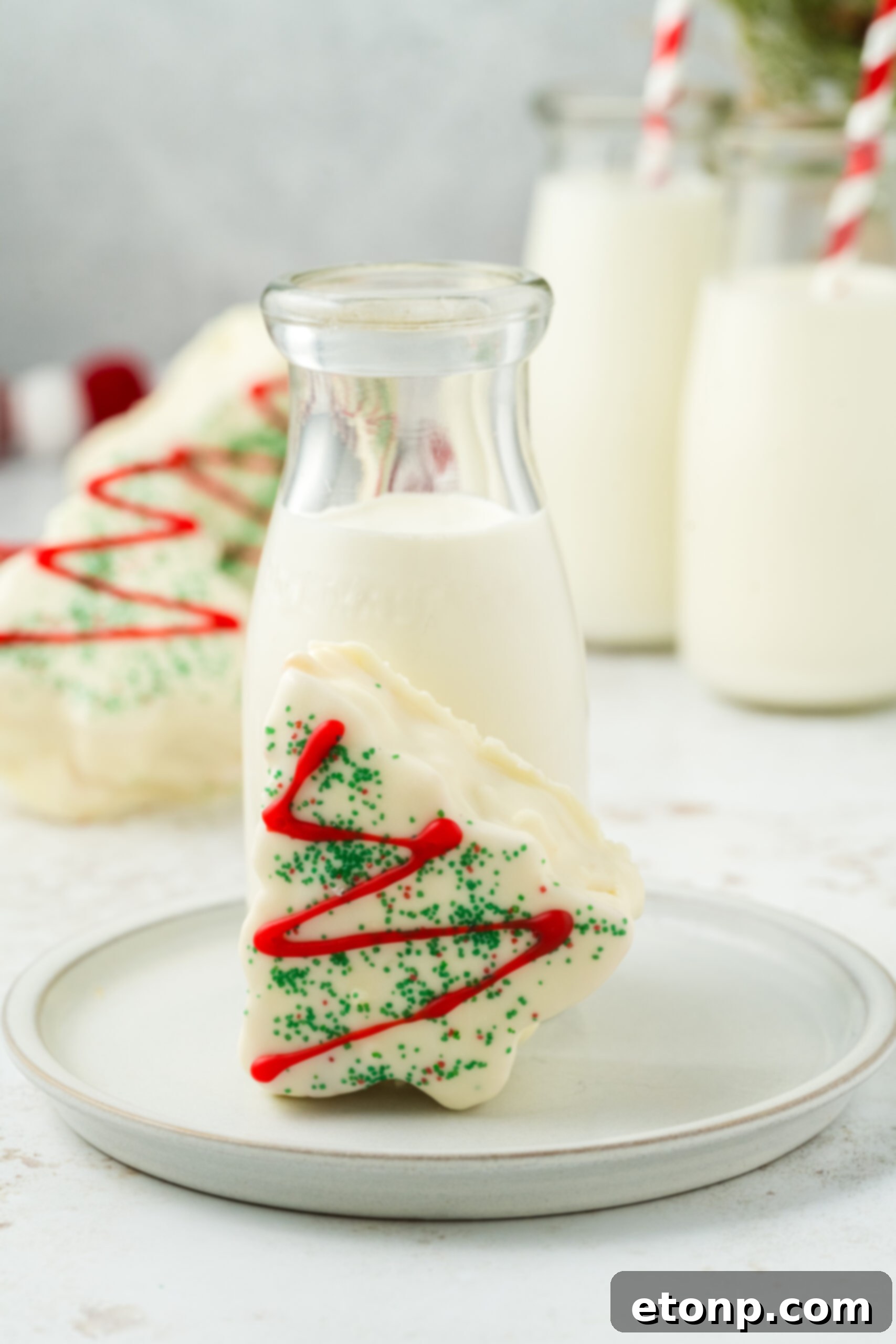Copycat Little Debbie Christmas Tree Cake on a plate with glass of milk behind it