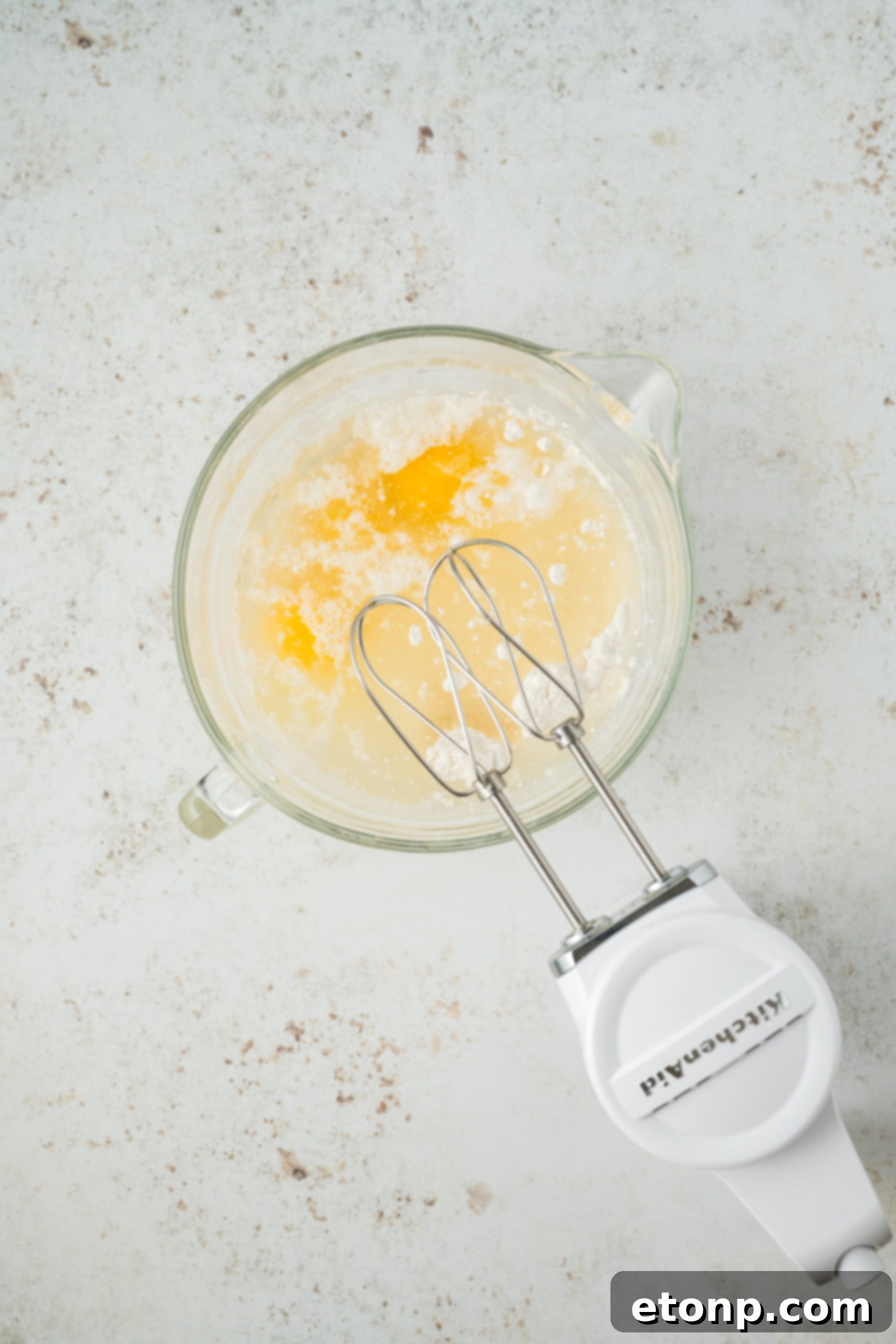 cake mix being mixed up in a glass bowl