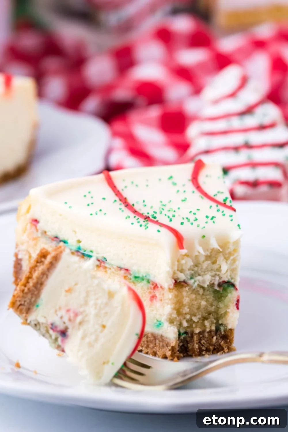 A close-up shot of a cheesecake slice on a plate with a piece bitten off, demonstrating its deliciousness.