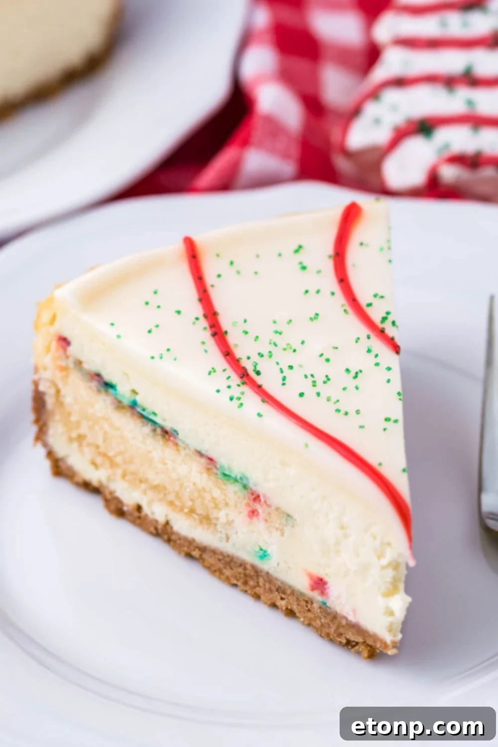 A delectable side view of the Christmas cheesecake on a plate, highlighting its layers and festive decoration.