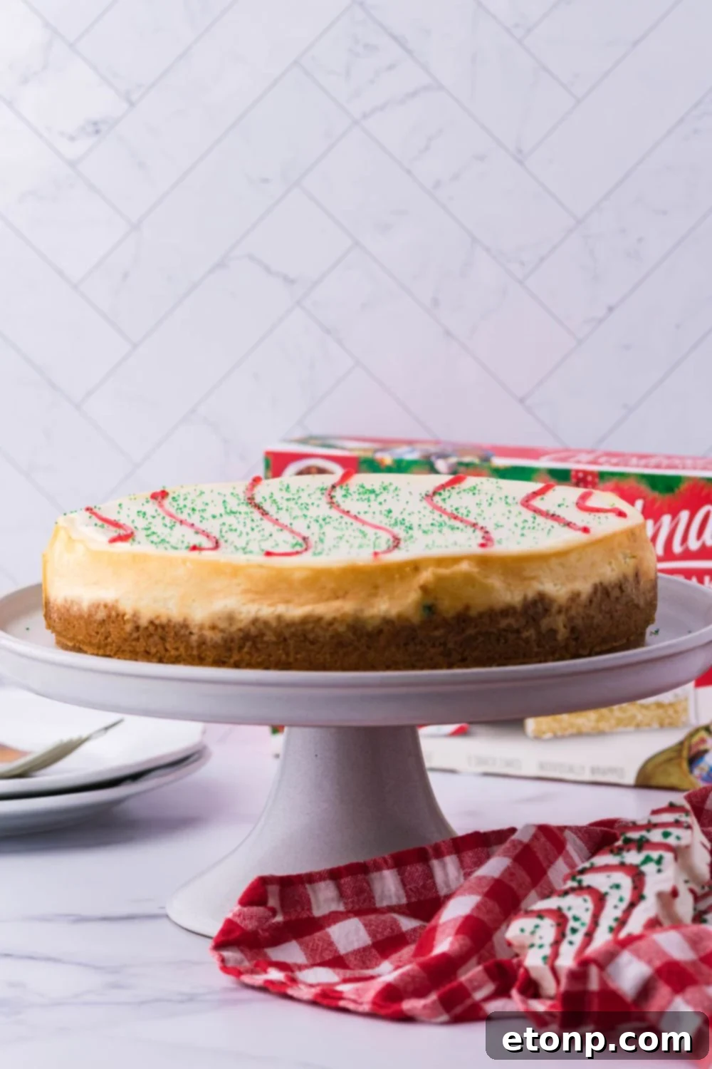 A festive cheesecake elegantly displayed on a cake stand, ready to be the centerpiece of a holiday table.