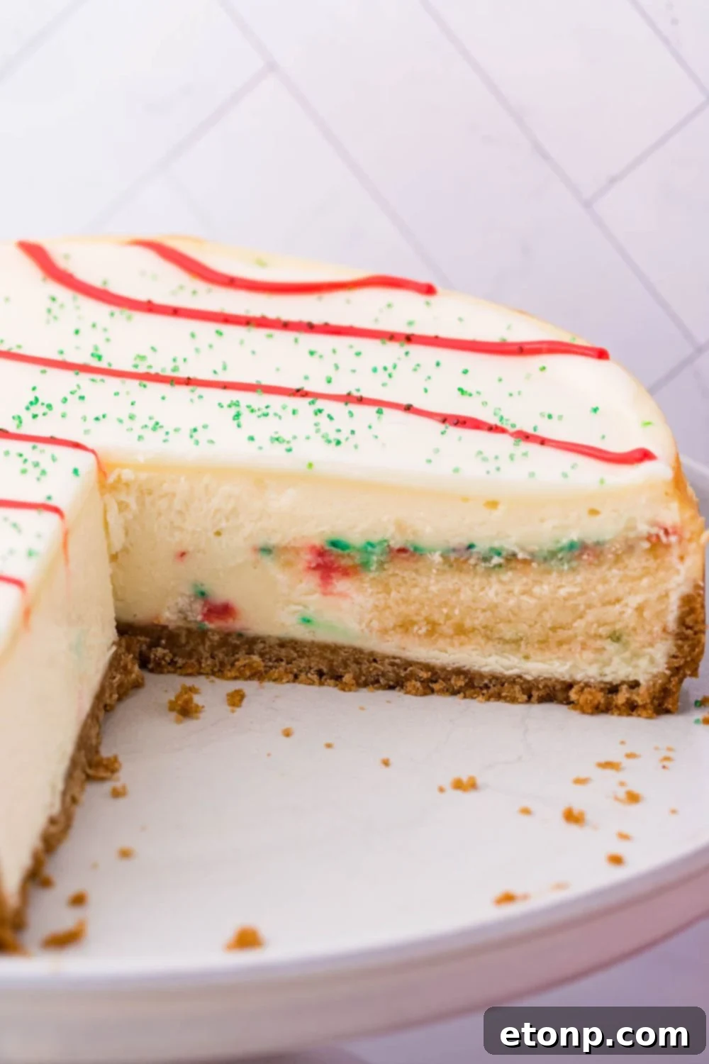 A beautifully sliced Little Debbie Christmas Tree Cheesecake on a platter, showcasing its creamy texture and festive layers, with several slices already removed.