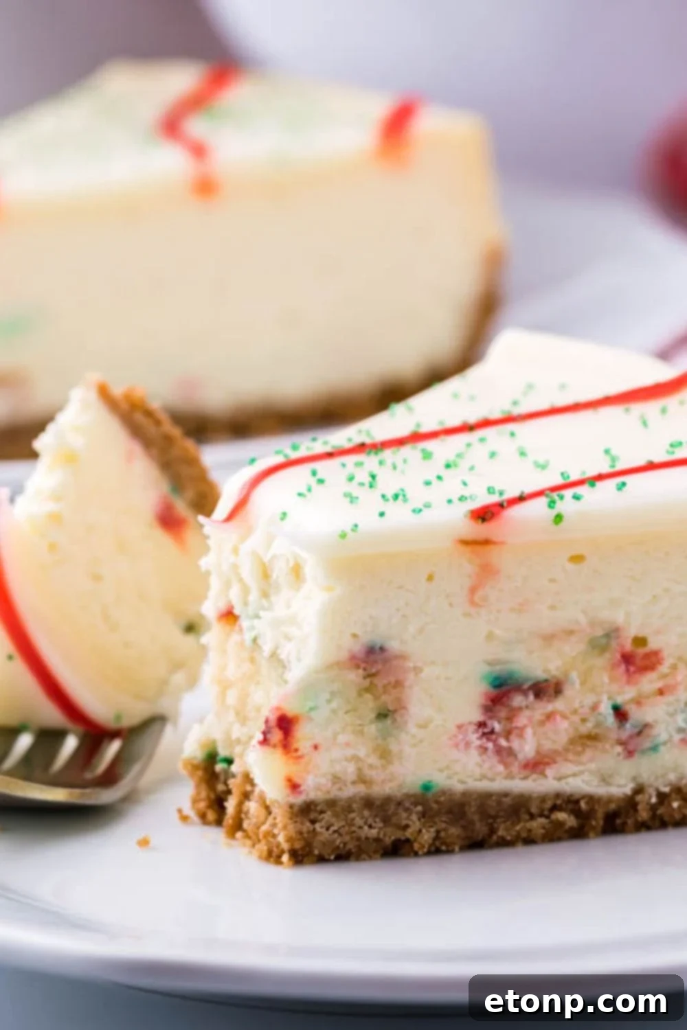 A close-up view of a baked cheesecake with a slice neatly removed, revealing its smooth, creamy interior texture.
