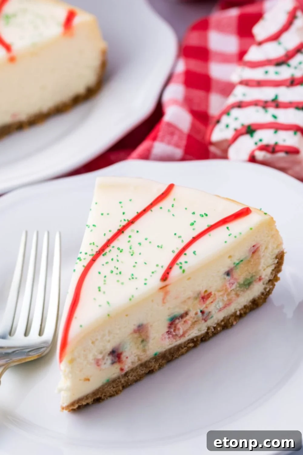 A close-up of a slice of cheesecake on a plate with a fork beside it, showcasing the rich texture and garnishes.
