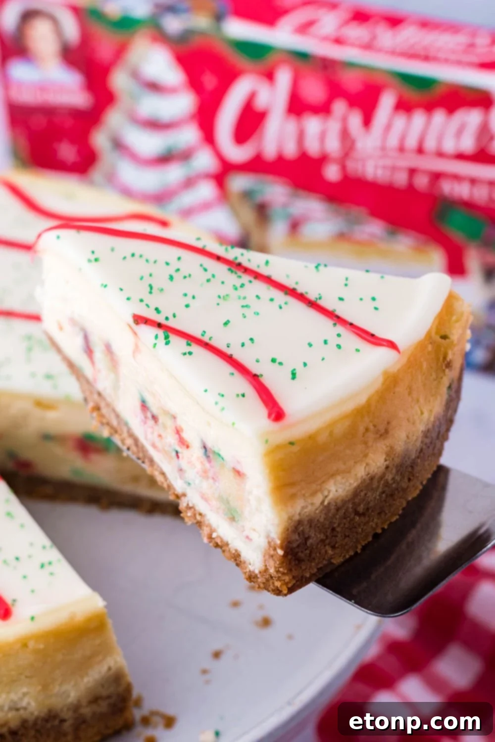 A spatula delicately holding a single slice of cheesecake, perfectly cut and ready to be transferred to a plate.