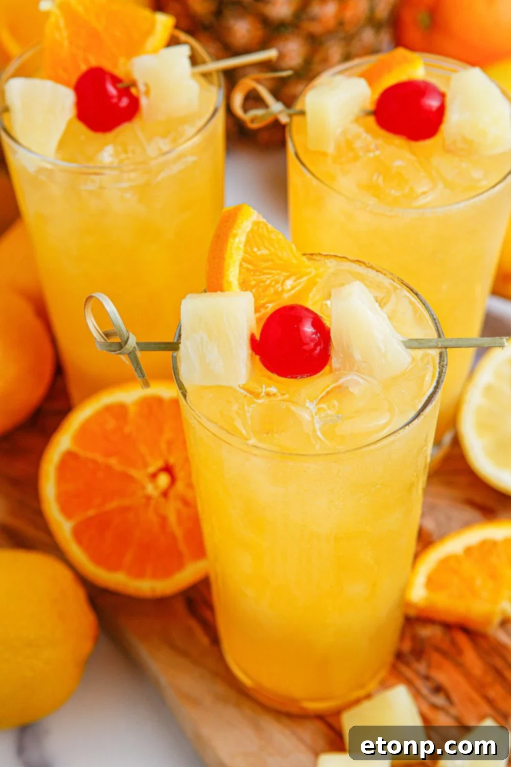 Tropical Lemonade Punch in glasses on table with fruit around it on table