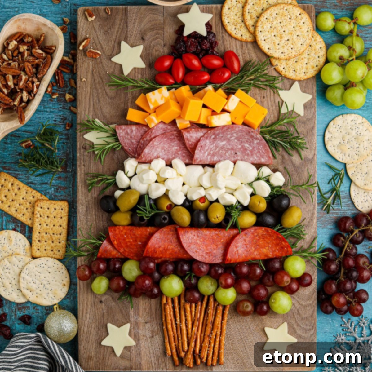 Christmas Tree Charcuterie Board on table with food around it, ready for holiday guests