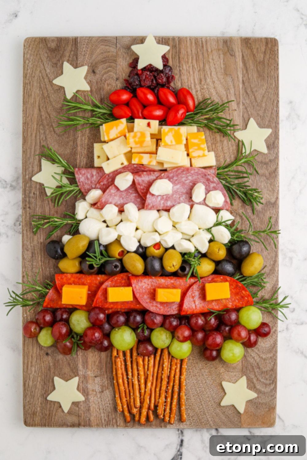 Overhead view of a tree shaped charcuterie board on a table