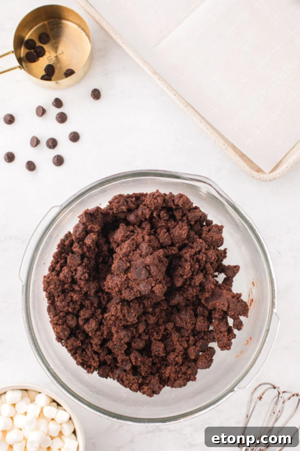 Smooth, mixed cookie dough in a mixing bowl, showing its rich chocolate color.