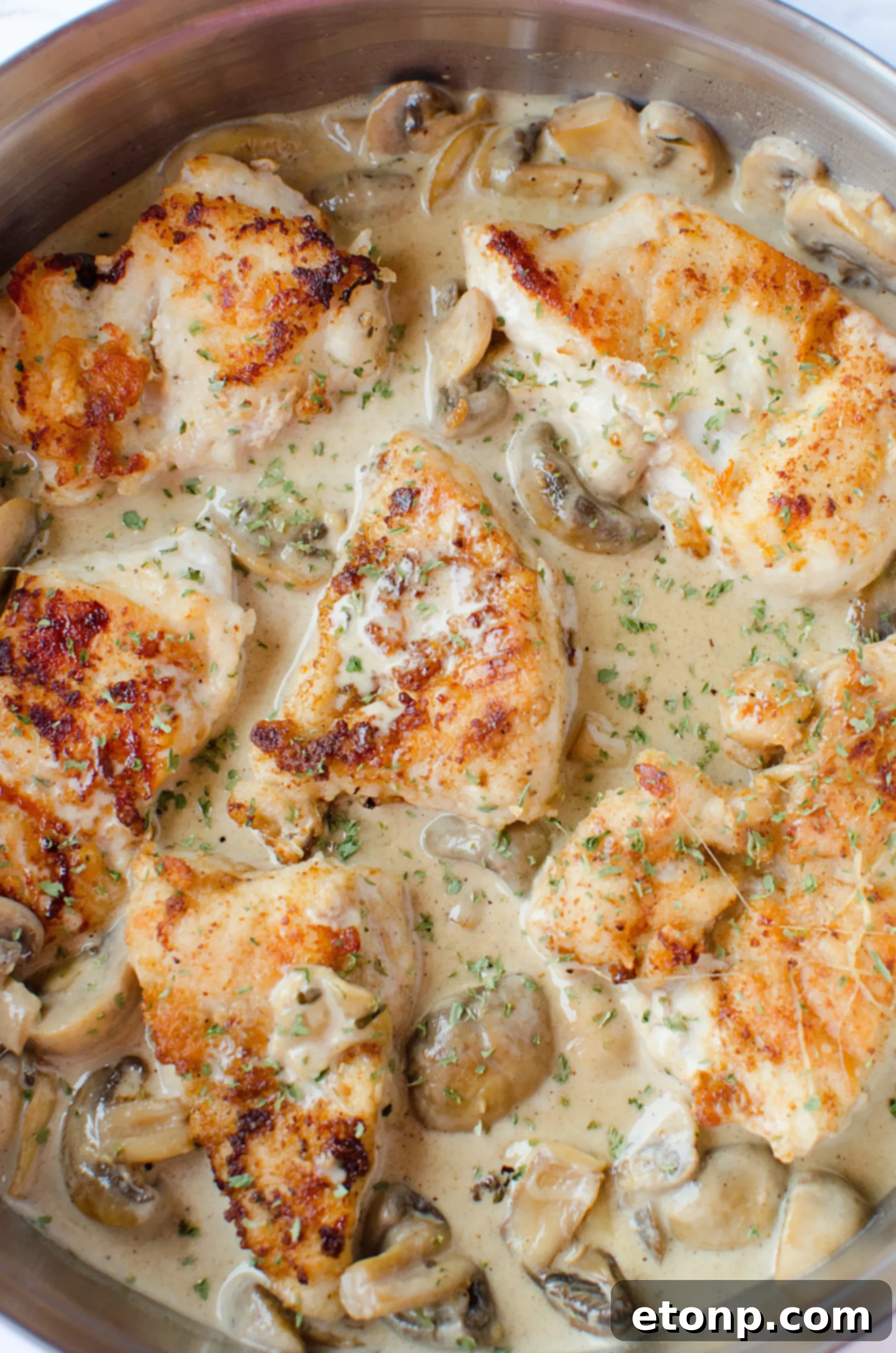 Overhead view of Creamy Asiago Chicken in a skillet, ready to be served
