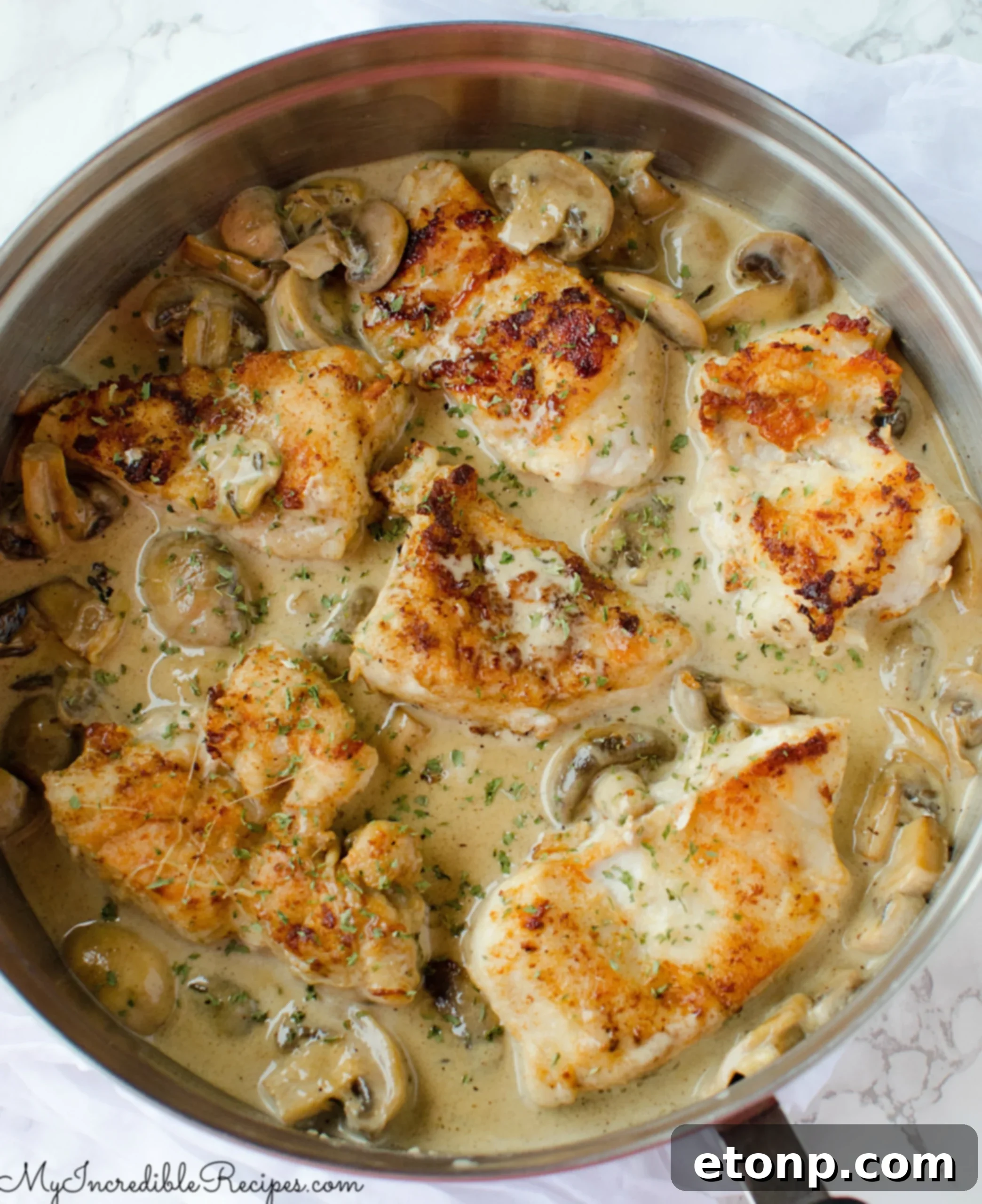 Final plated dish of Creamy Asiago Chicken with a side