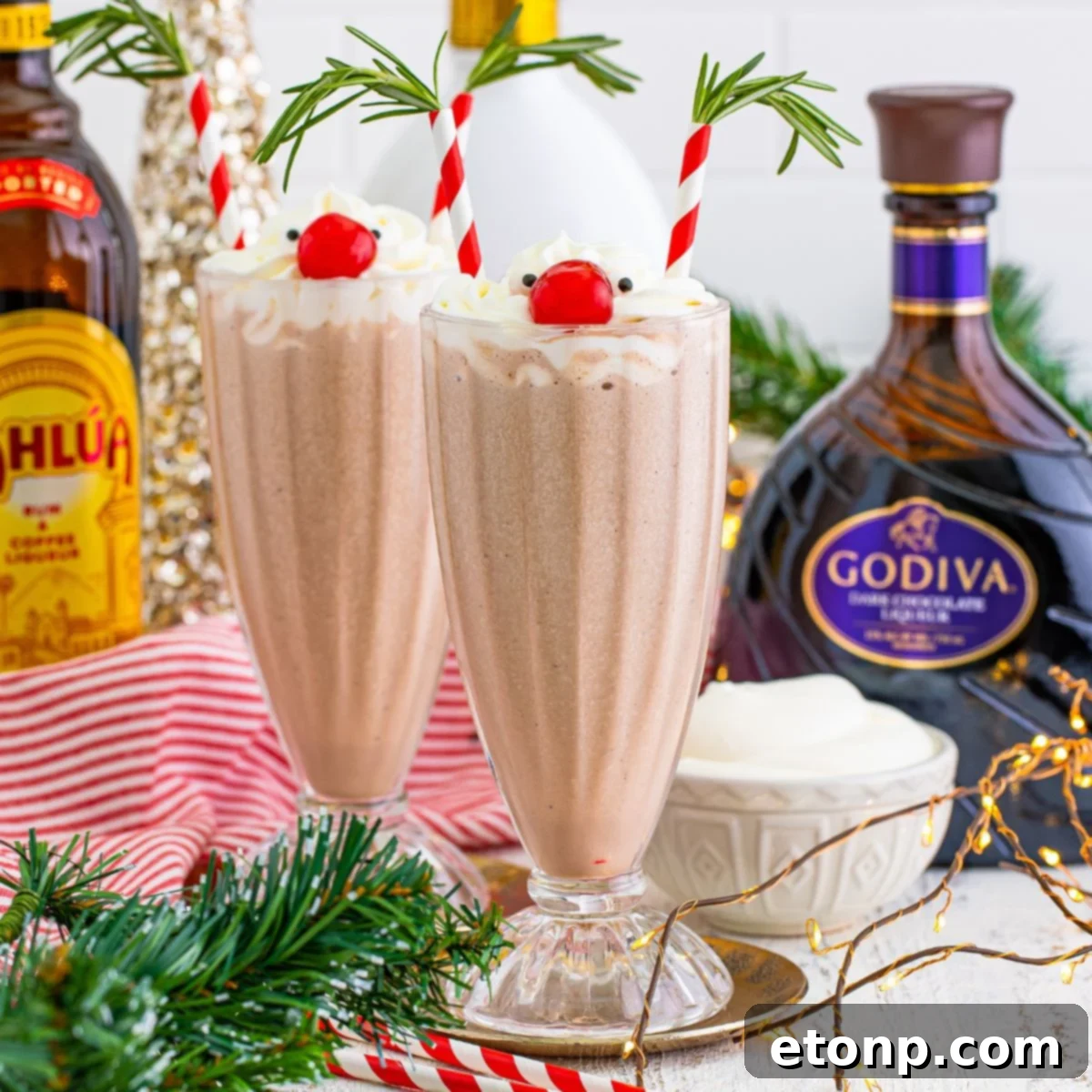 Drunk Rudolph Milkshakes on table with alcohol behind glasses 