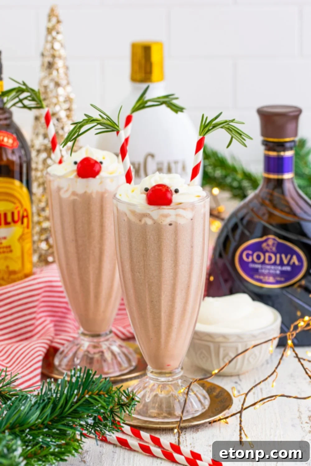 drunken rudolph drinks in glasses with ingredients and decorations around it on table