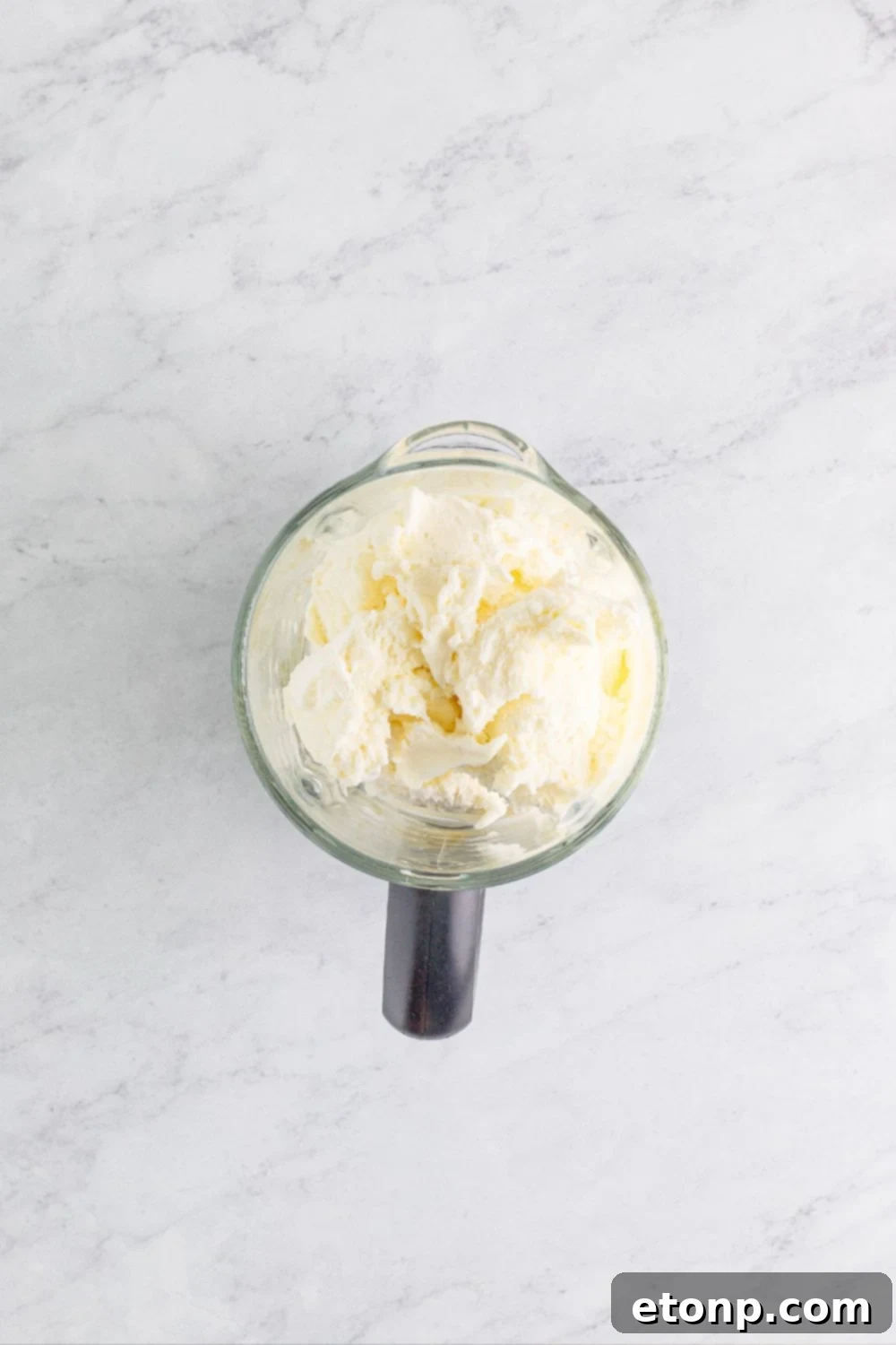 blender with ice cream sitting on table 