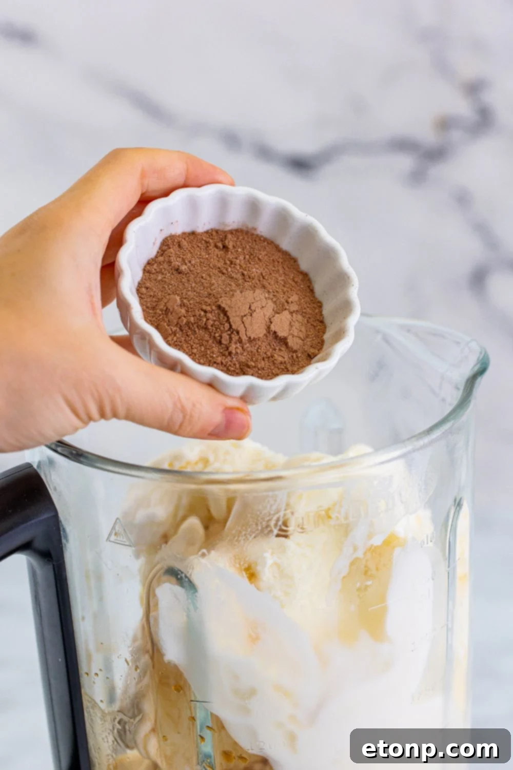 adding hot chocolate mix into bledner 