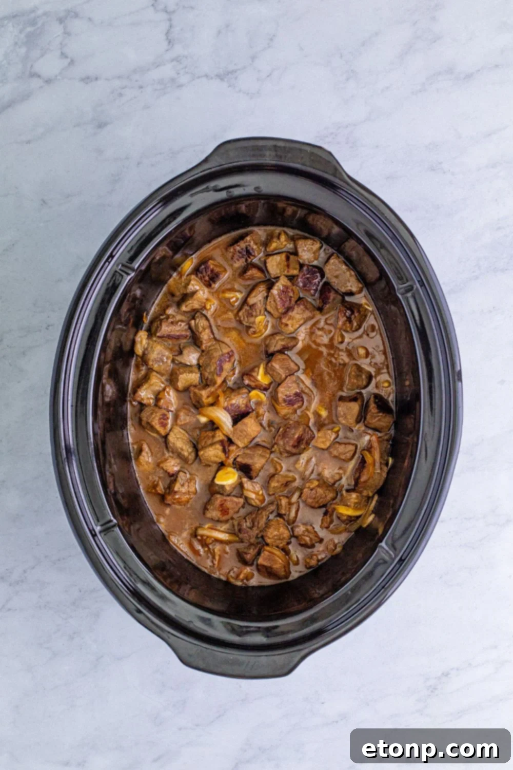 cooked steak bites in a slow cooker