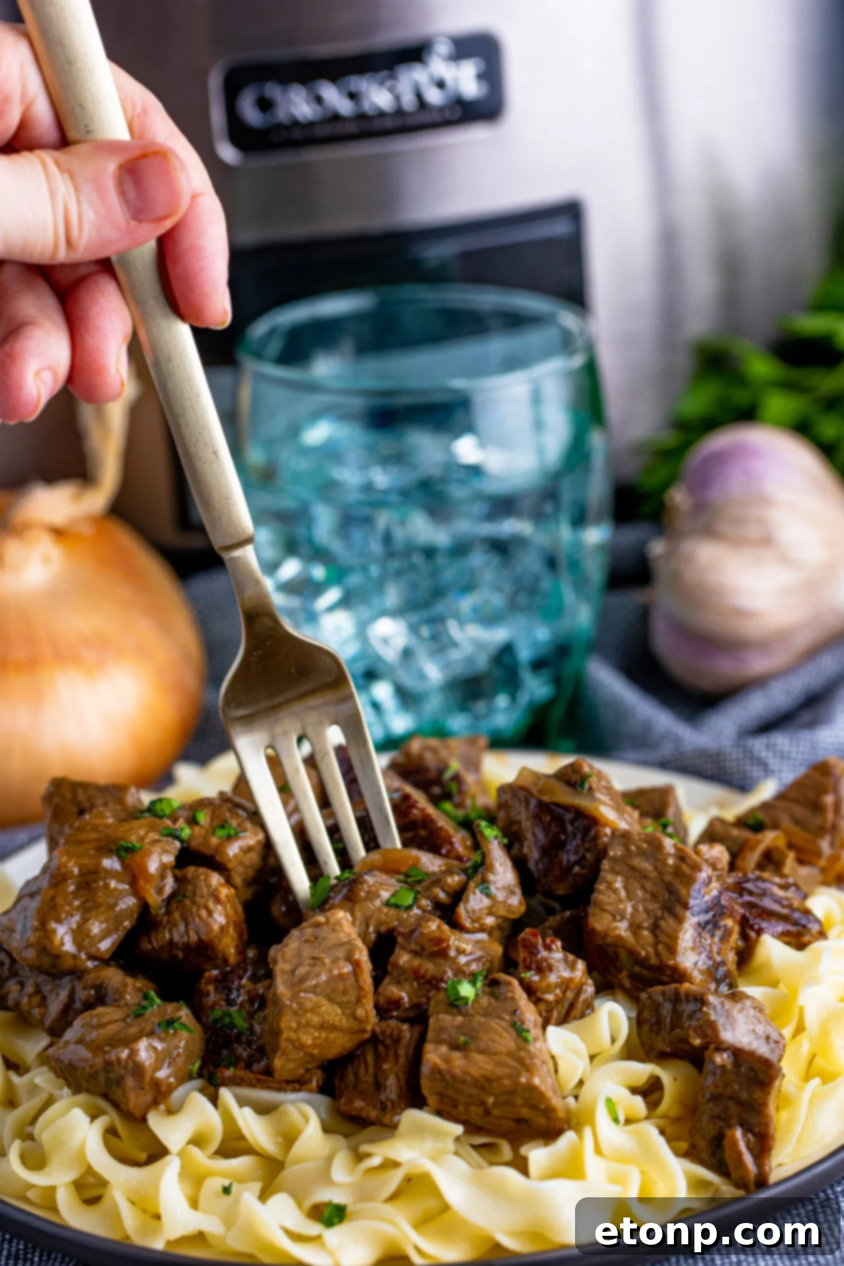 fork poking into steak bites on plate