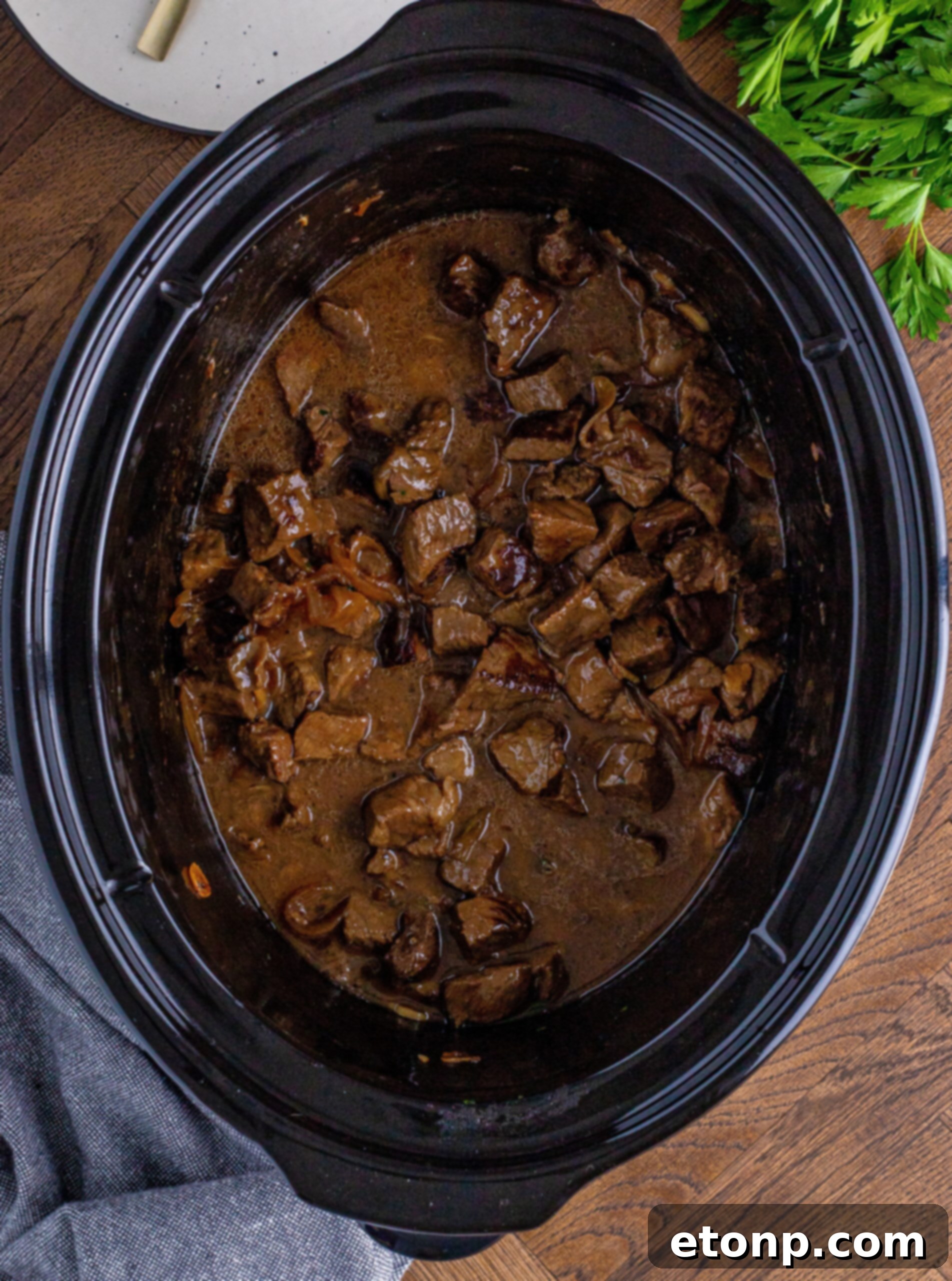 Crock pot Steak bites in a black crock pot 