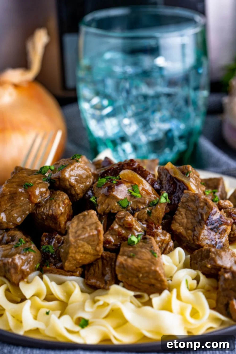 plate with steak and noodles on table 