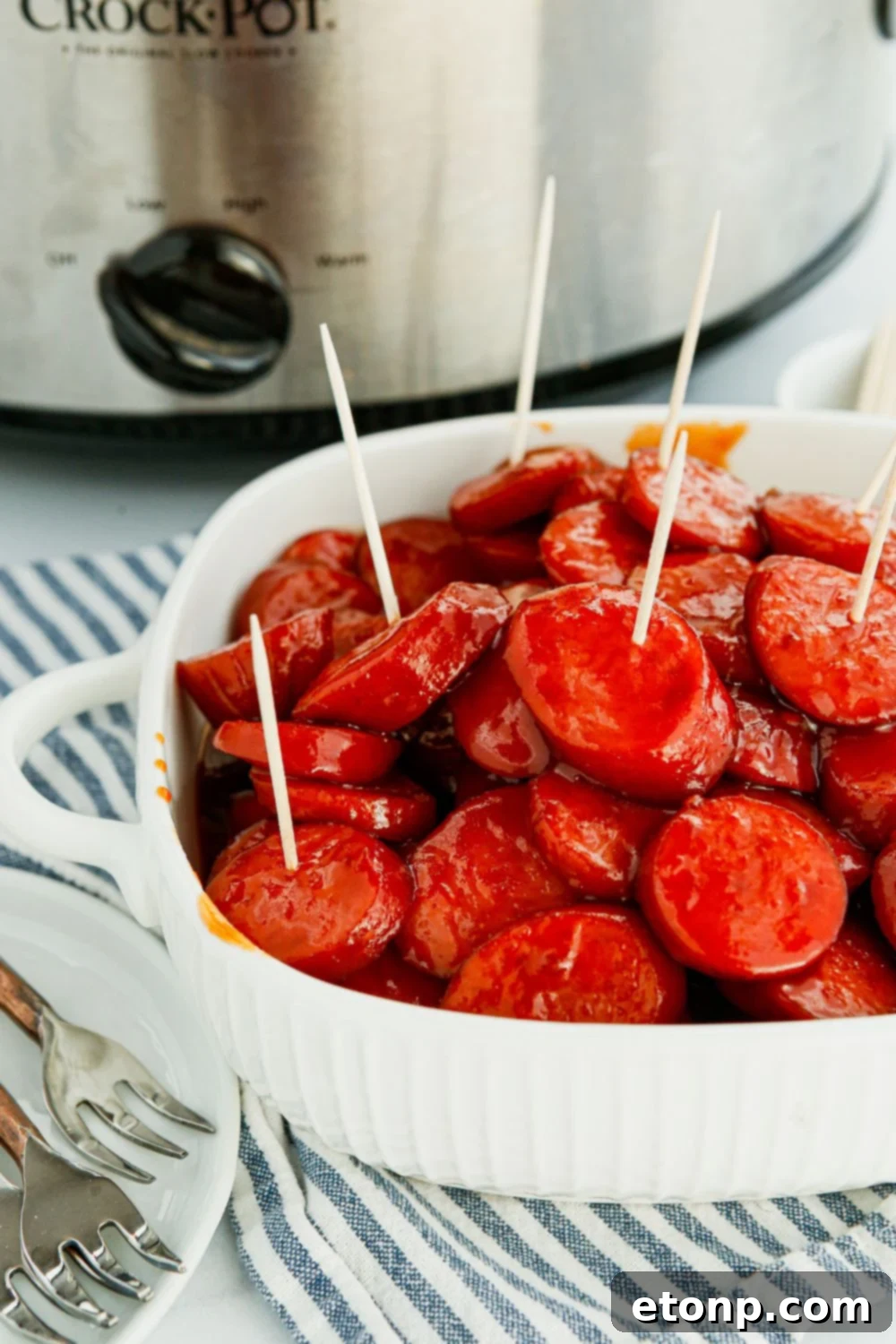 A charming bowl of Crockpot Kielbasa Bites, garnished with toothpicks, inviting guests to enjoy.