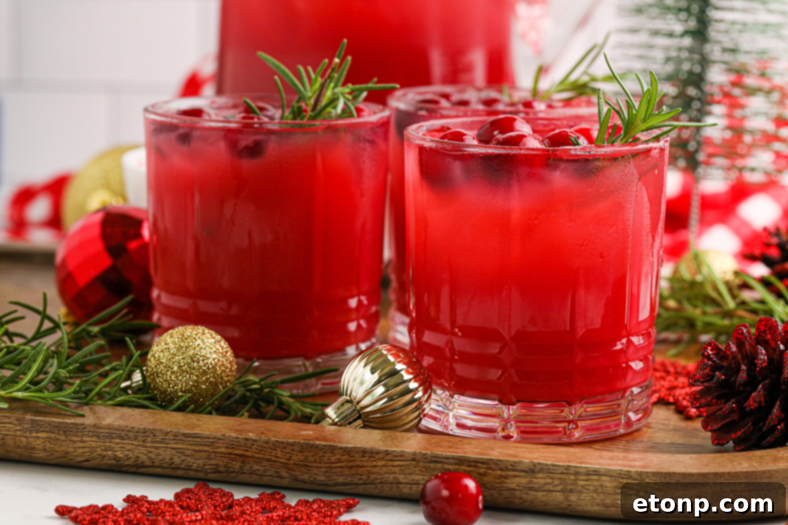 A holiday party scene featuring multiple glasses of Mistletoe Punch on a table, ready for guests to enjoy.