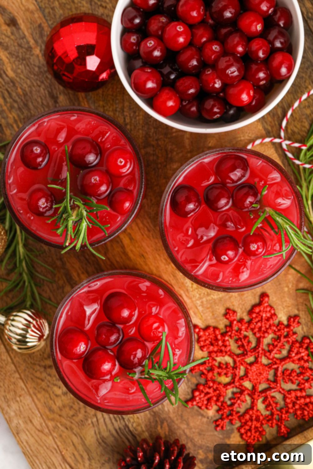 Glasses of Mistletoe Punch artfully arranged on a table, reflecting festive lights and holiday decor.