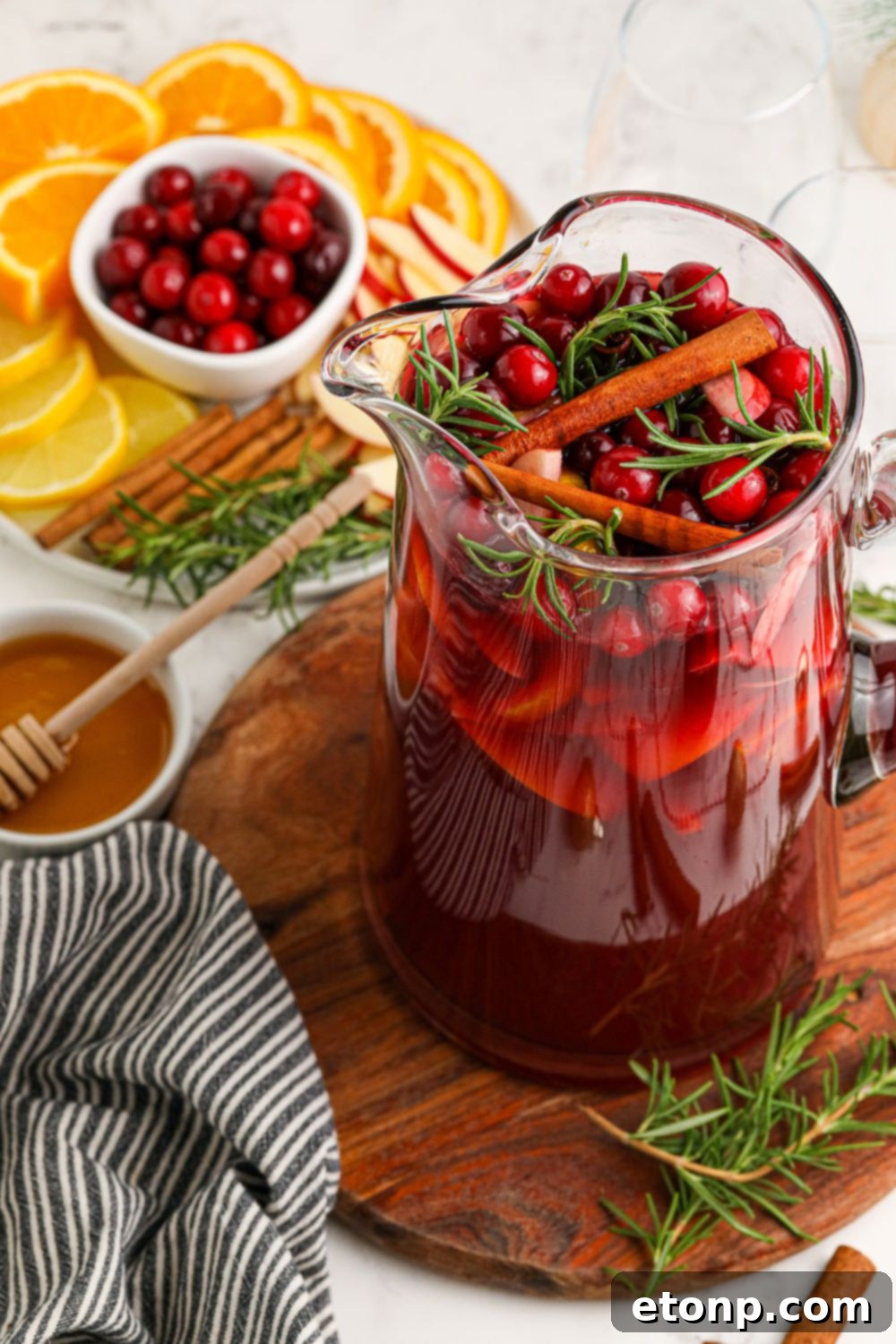 view of pitcher with sangria with fruit and such around the container 