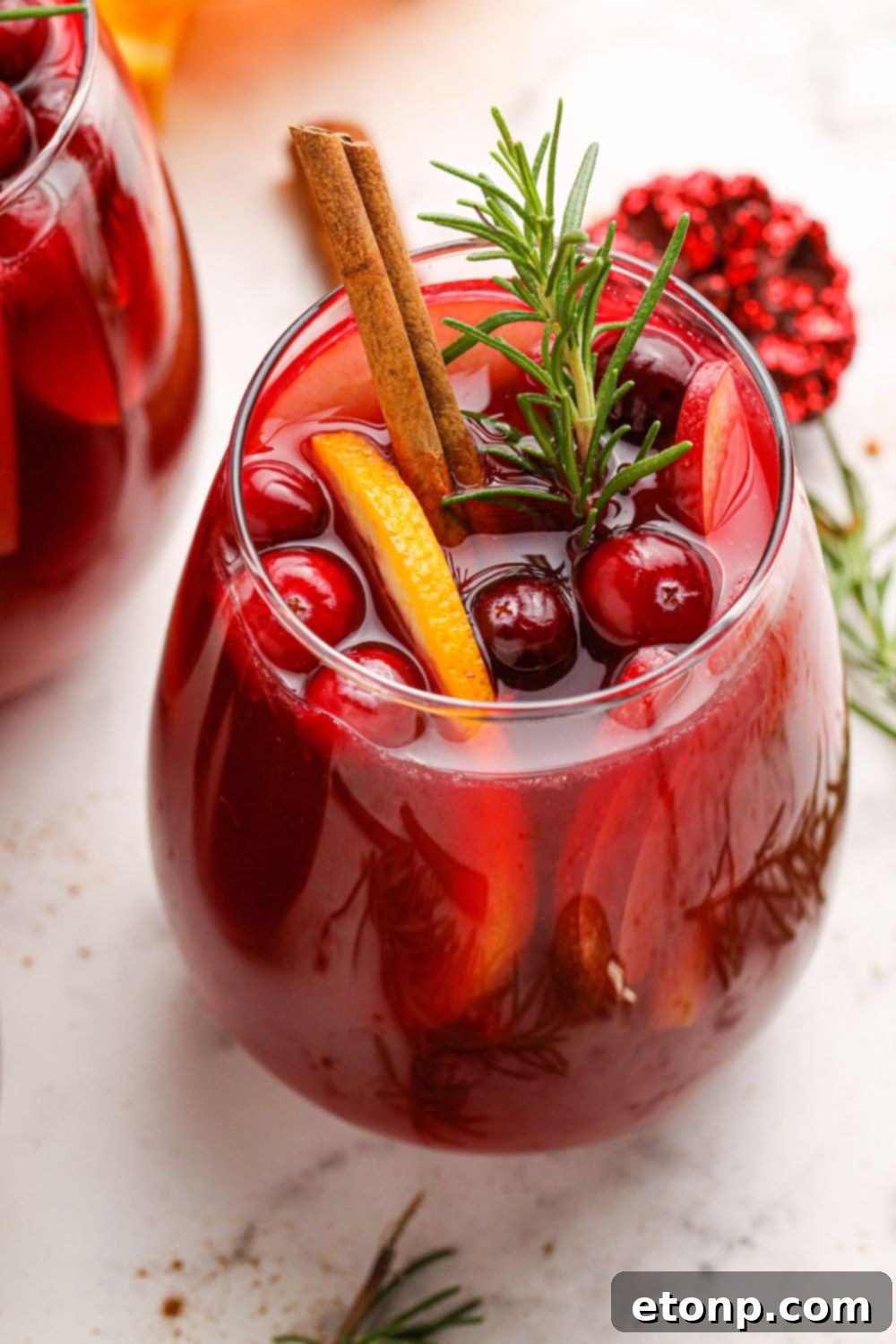glass of wine with fruit in it on a marble table