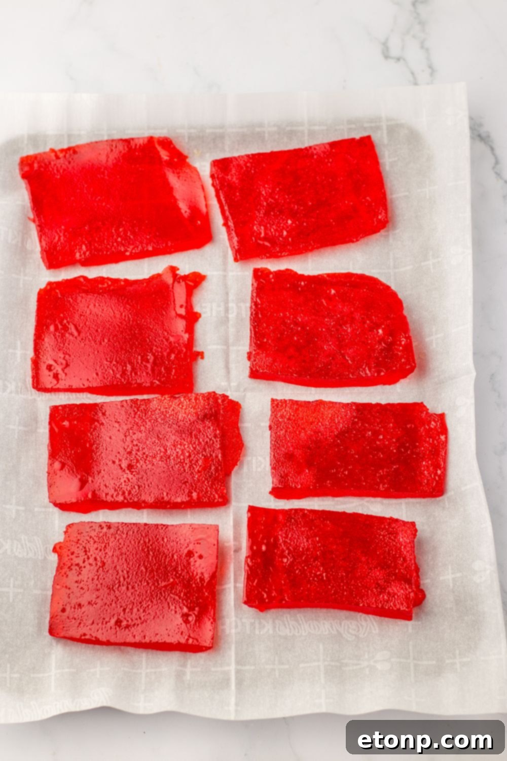 Holiday Gumdrop Gems 11 Slices of set red jello mixture ready for shaping in a pan
