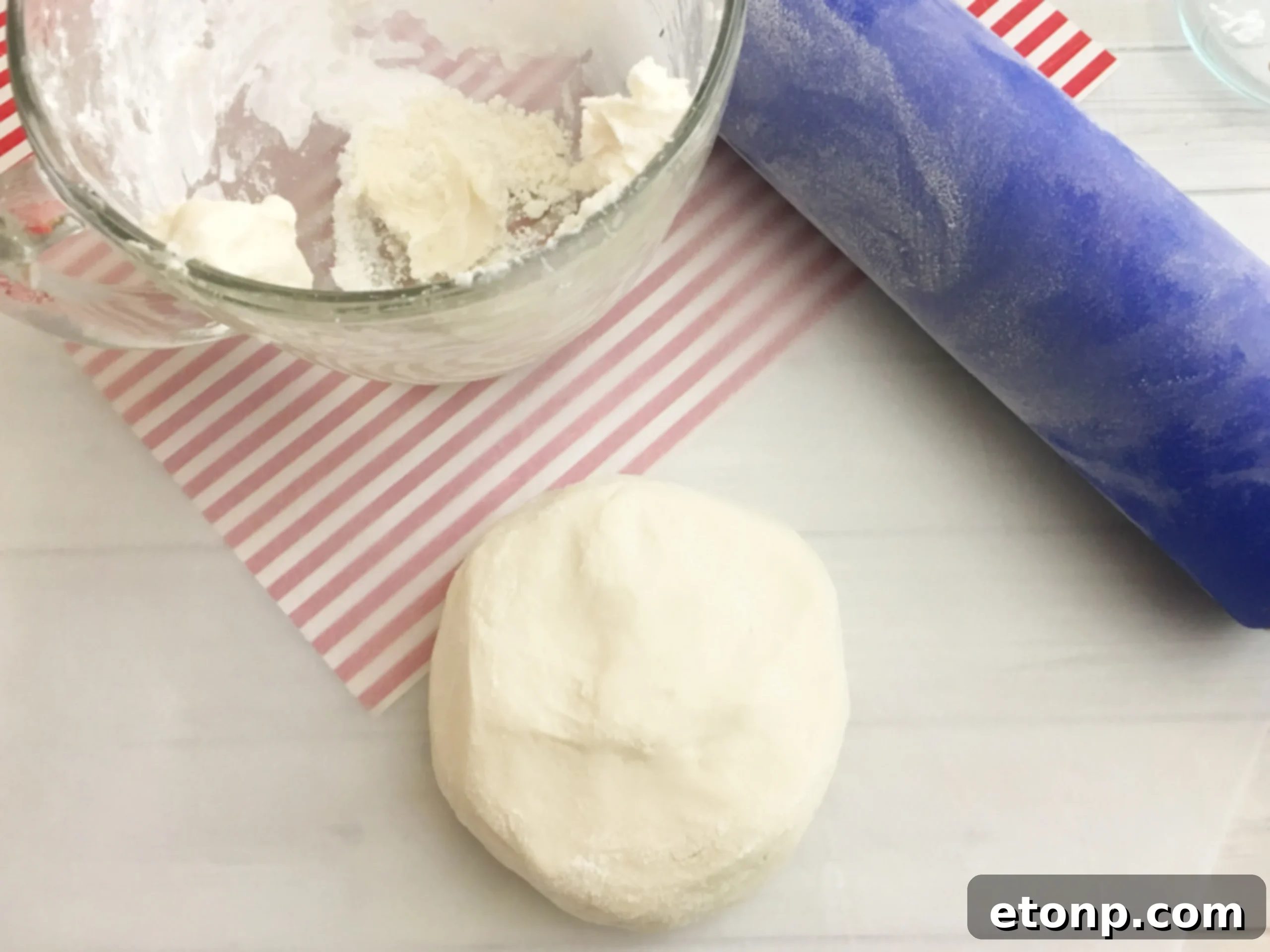 A batch of freshly made peppermint patties cooling on parchment paper, ready for their final chocolate dip.