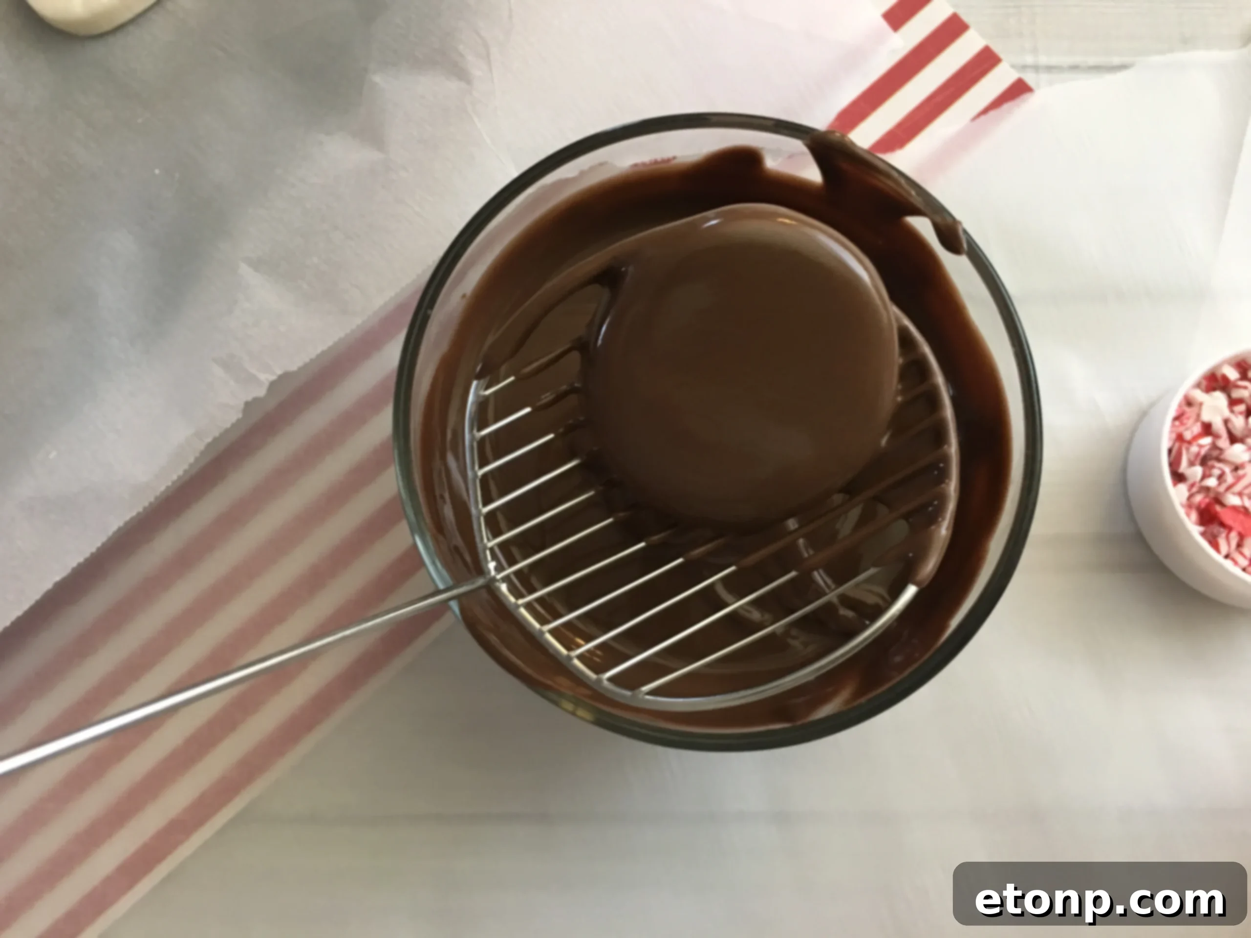 An overhead shot of multiple peppermint patties, showcasing their round shape and glistening chocolate coating, with crushed candy cane topping.