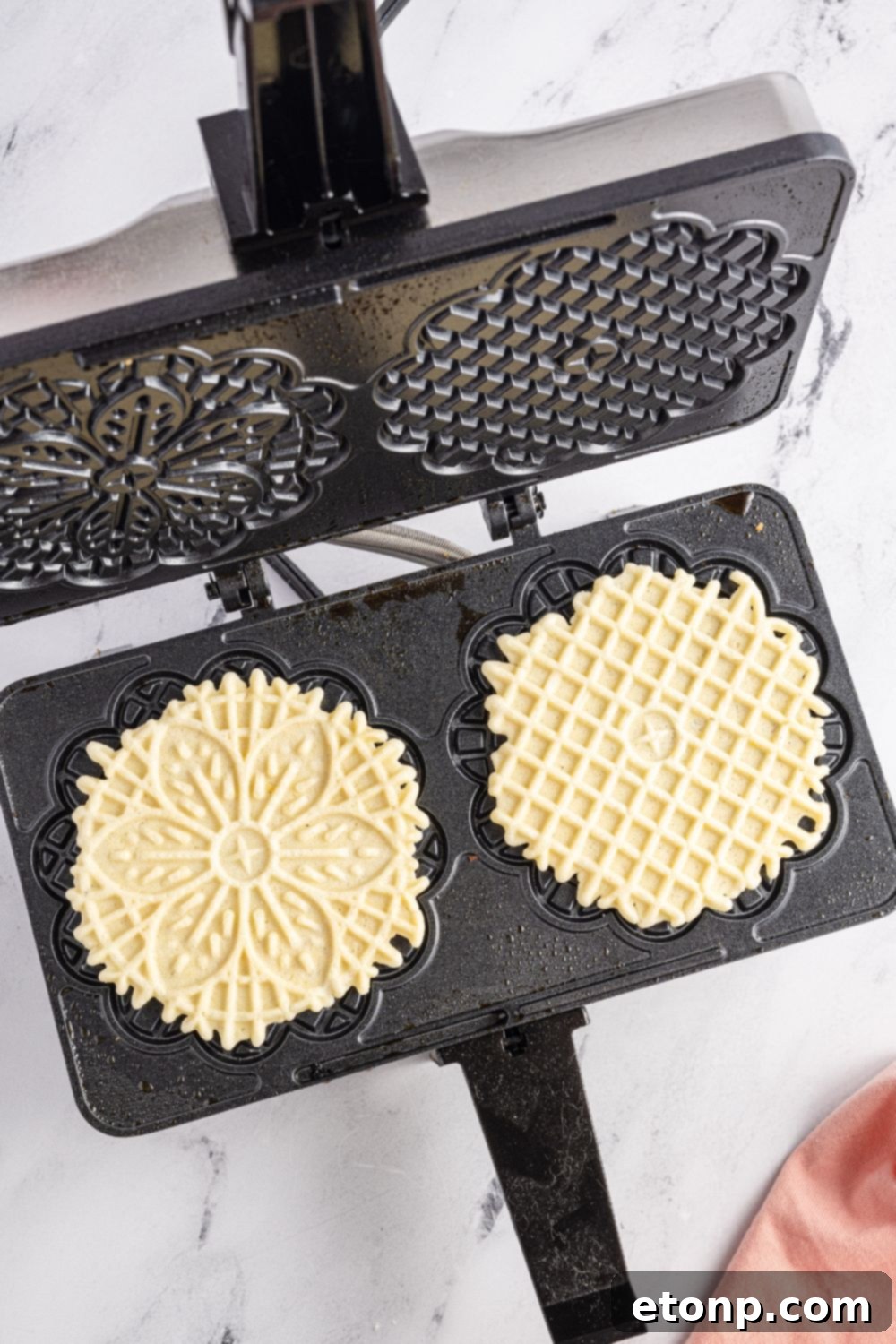 Pizzelles 14 Pizzelles in iron on table