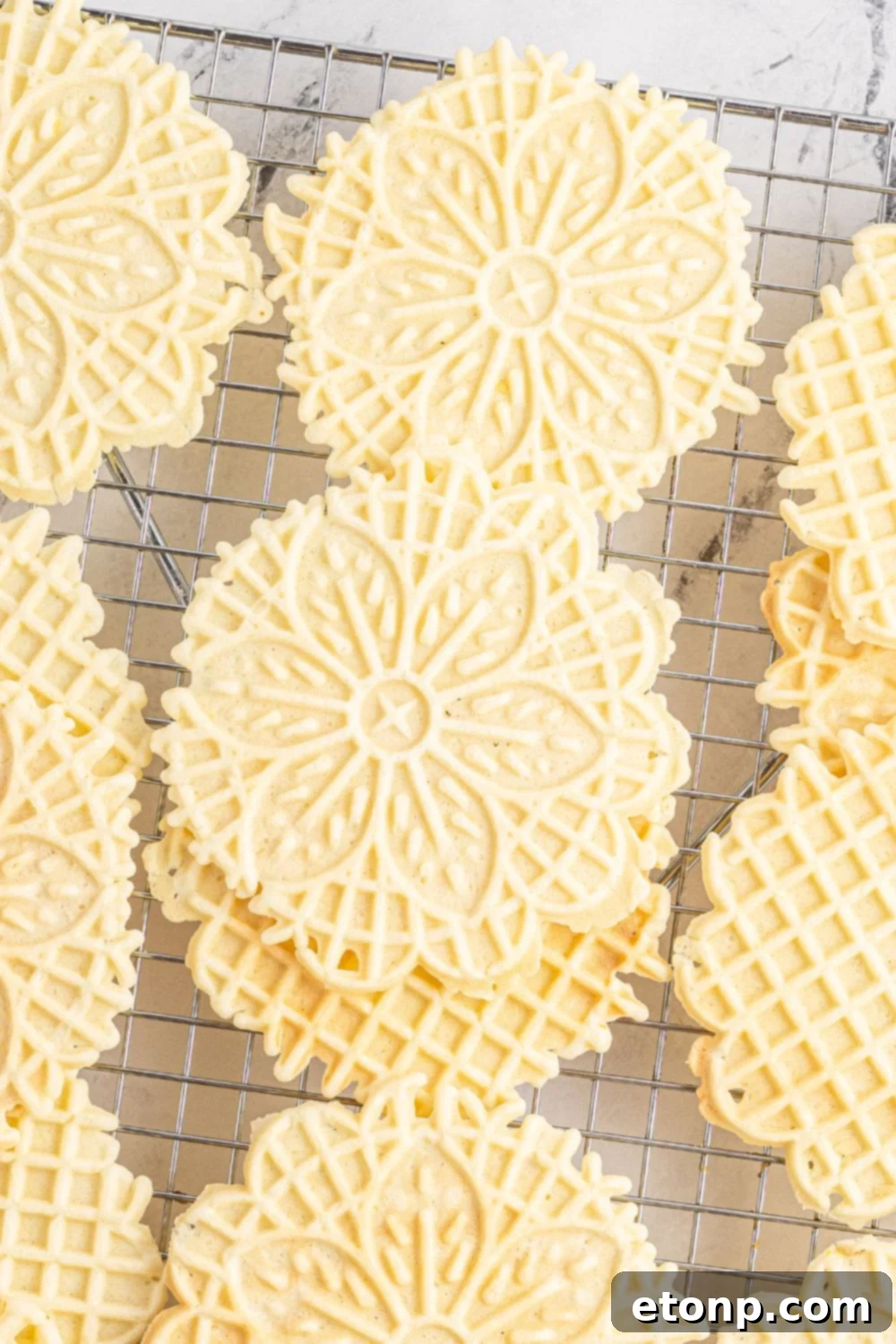 Pizzelles 22 Pizzelle cookies stacked on a cooling rack