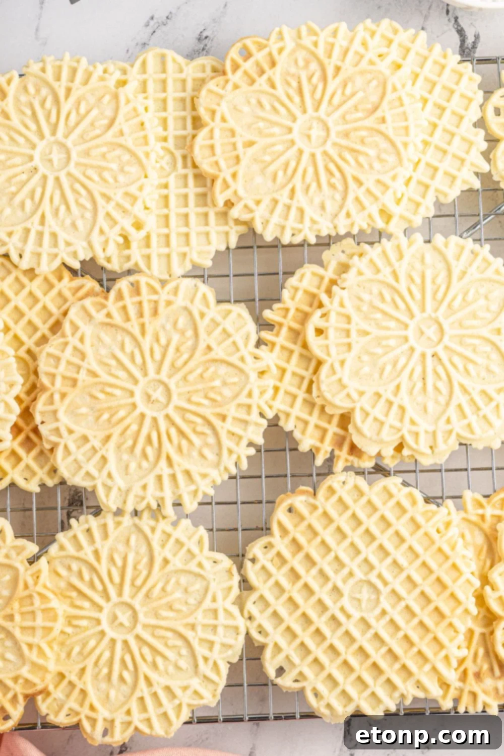 Pizzelles 4 pizzelle cookies on a cooling rack