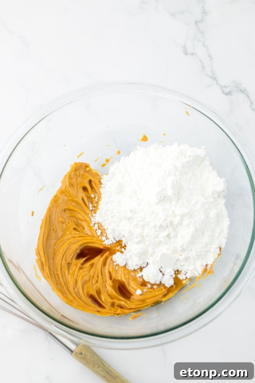 Peanut butter and powdered sugar mixed up in a bowl