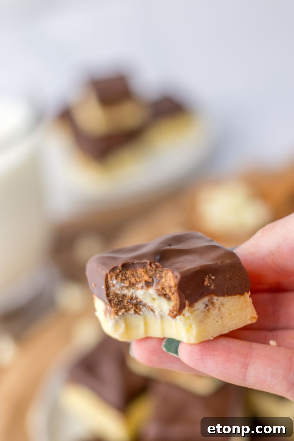 holding a piece of fudge with bite taken out