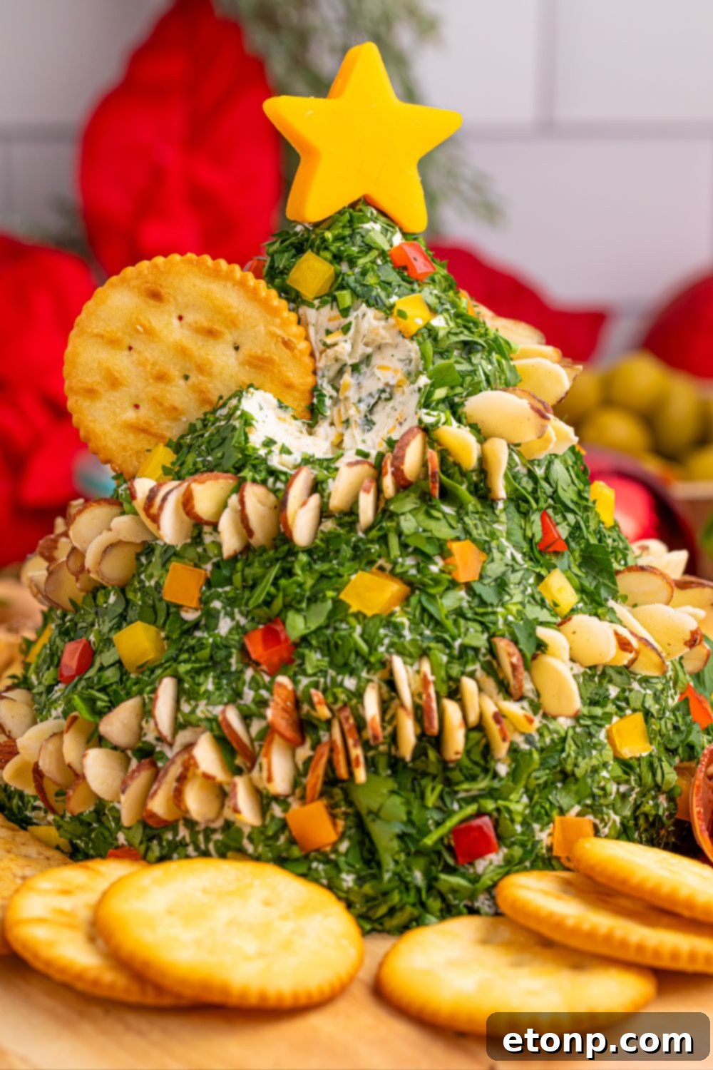 Christmas Tree Cheeseball appetizer displayed on a table with other foods