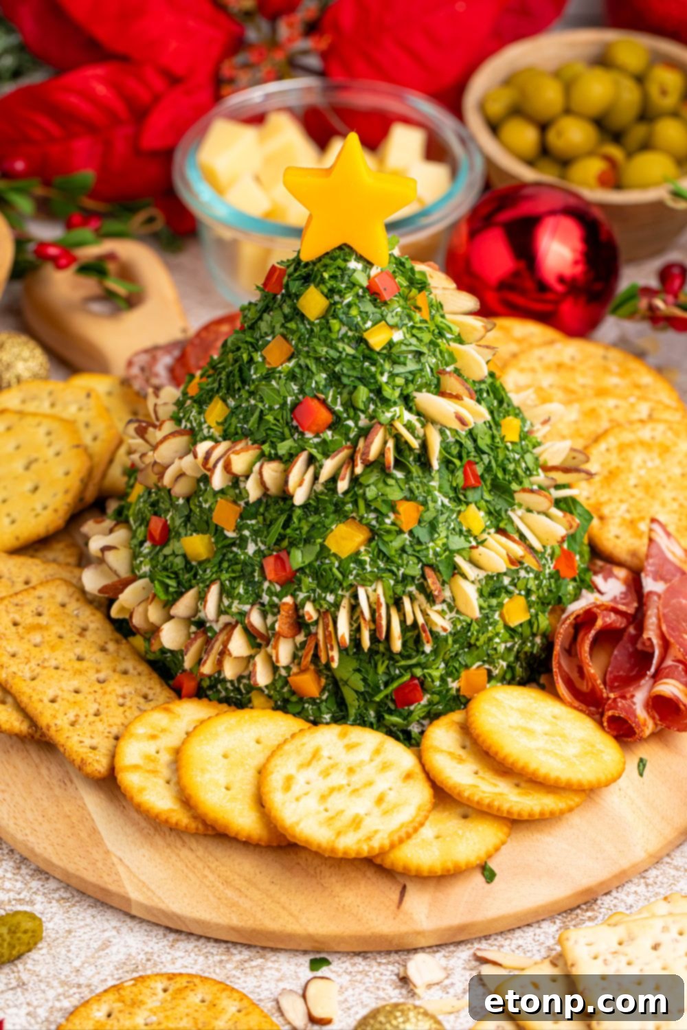 Appetizer on a platter surrounded by crackers and fresh rosemary sprigs