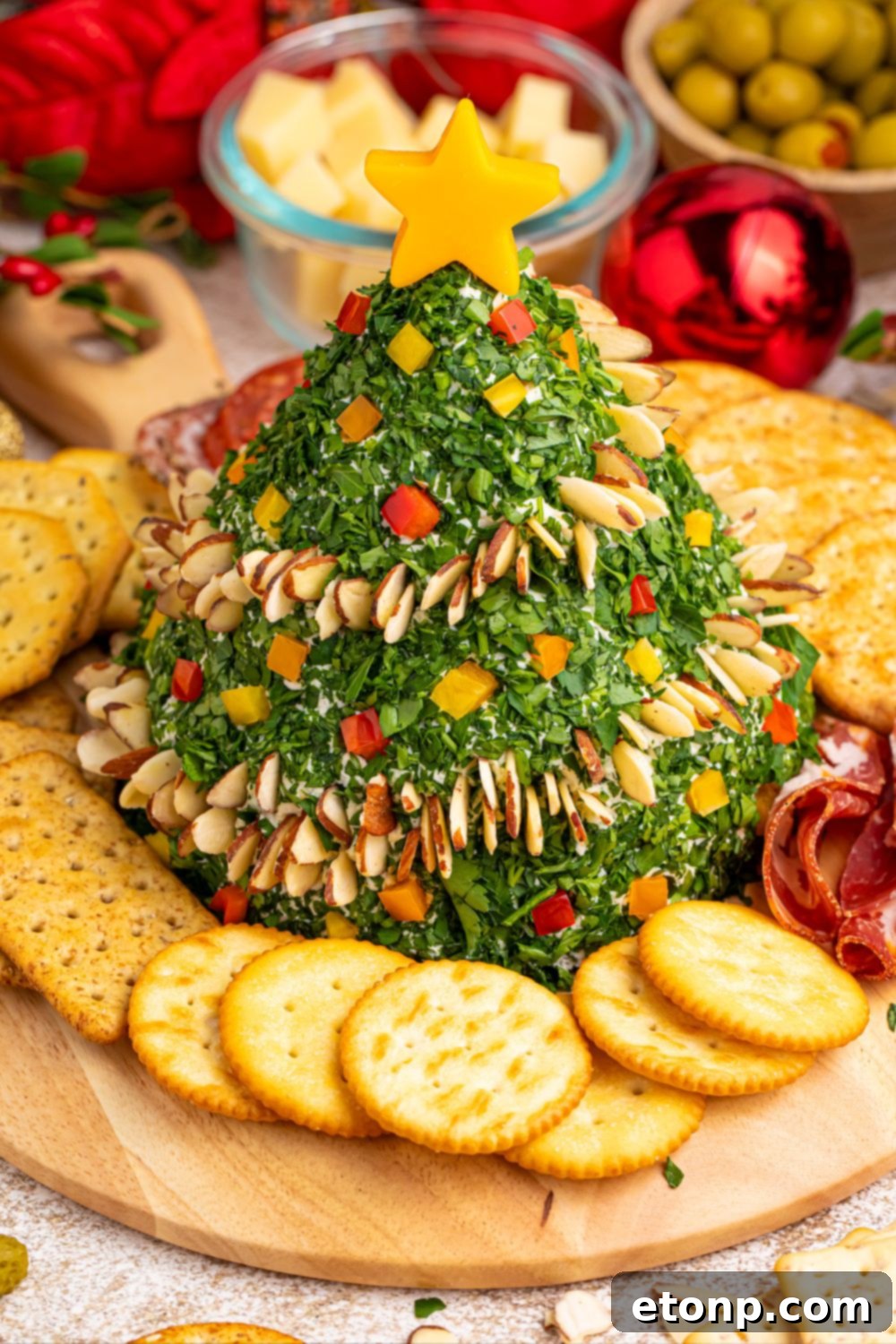 Christmas Tree Cheeseball showcased on a table with various crackers
