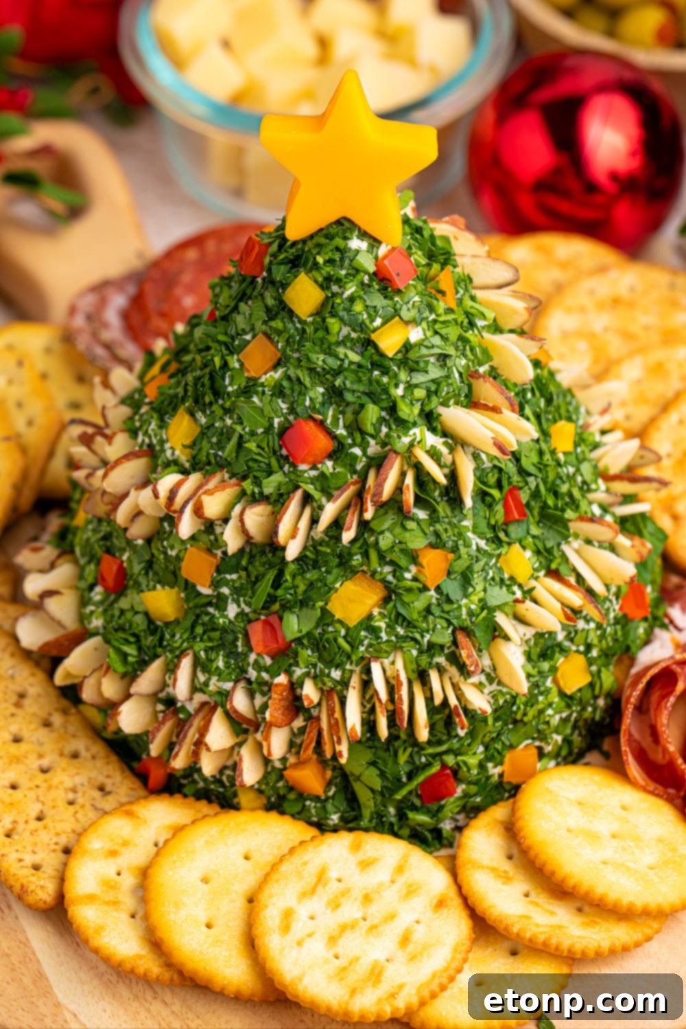 Christmas tree dip on platter surrounded by an assortment of crackers