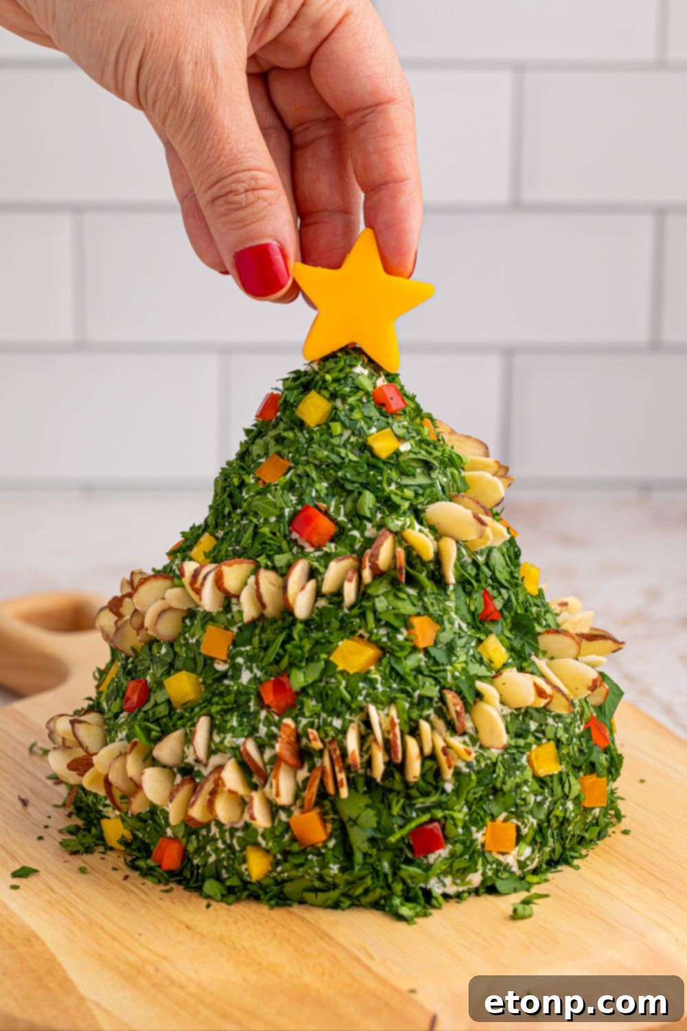 Decorated cheeseball with a cheese star on top on a wooden table