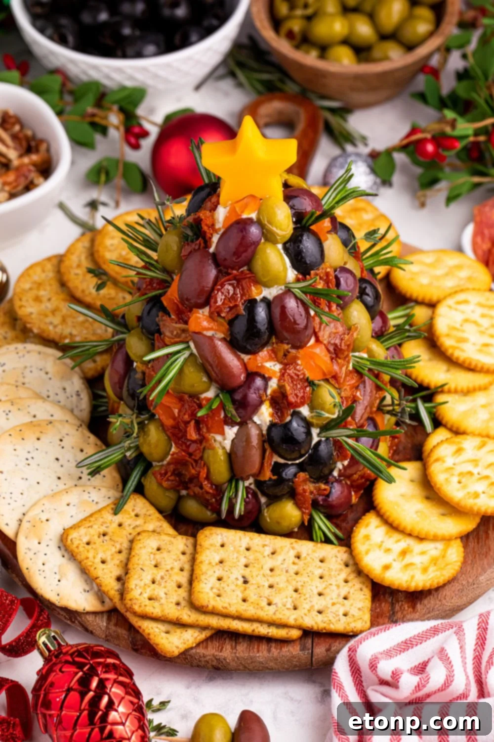 An appealing overhead view of the Christmas tree shaped cheeseball, beautifully presented on a platter, adorned with colorful antipasto elements.