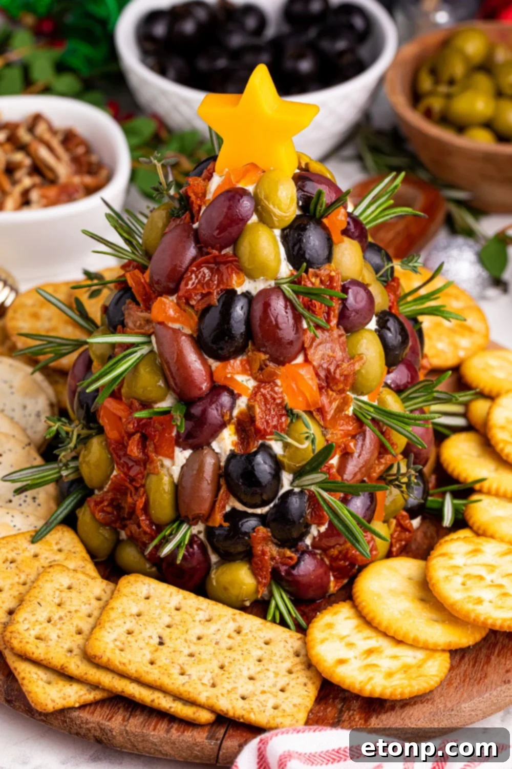 An overhead shot of the elegantly presented cheeseball on a table, emphasizing its perfect shape and festive decorations.