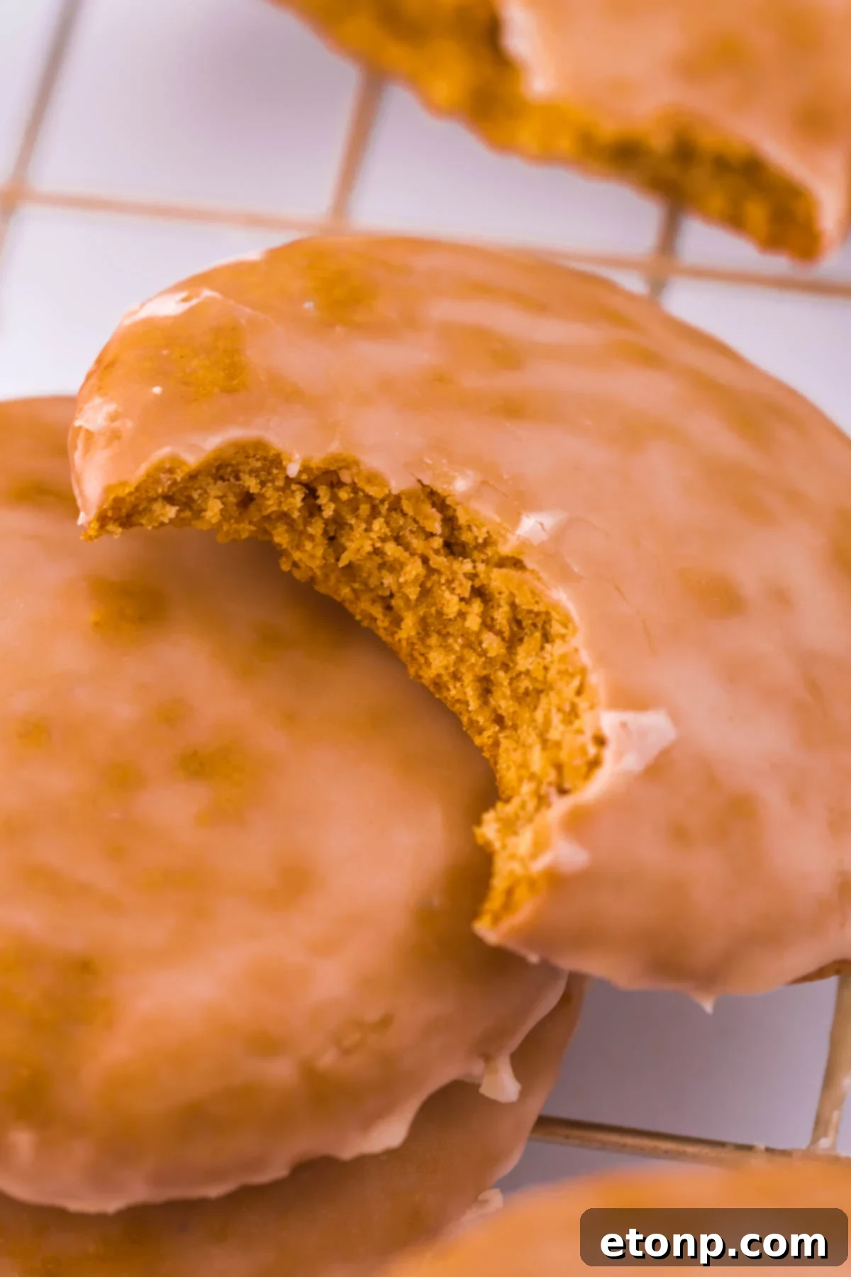 Gingerbread cookie on a table with a bite taken out of it, showcasing its soft texture