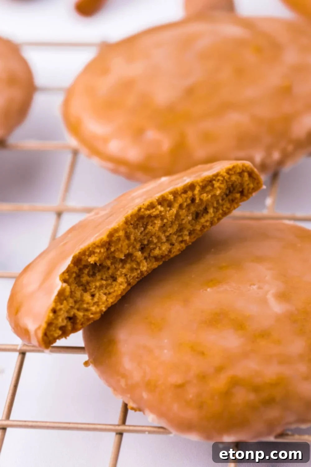 A cookie cut in half on a cooling rack, showcasing its soft interior